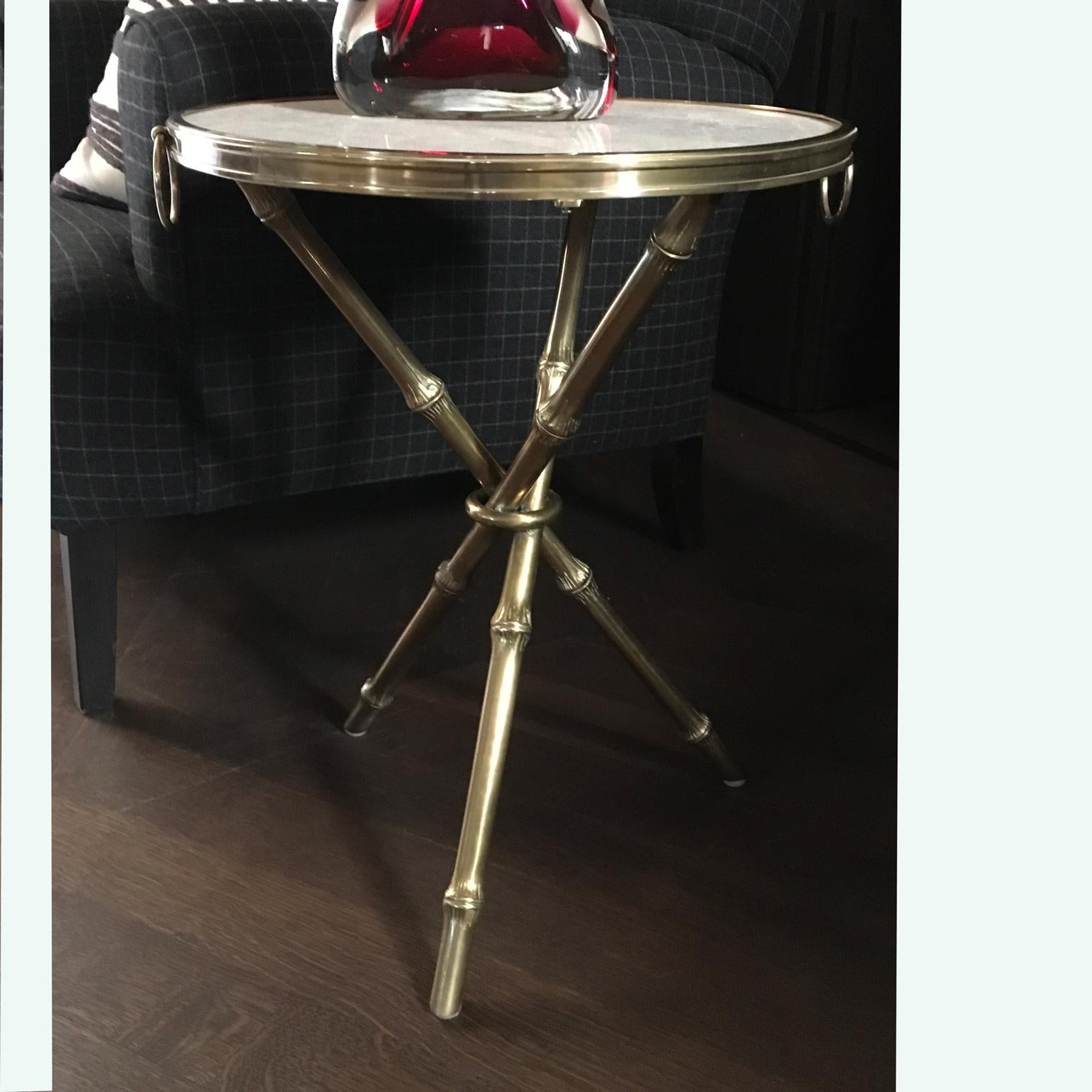 Gold-tone metal Ralph Lauren side table with limestone marble top, bamboo-form legs and two handles at side.
Piece of glamorous style and timeless elegance.
 