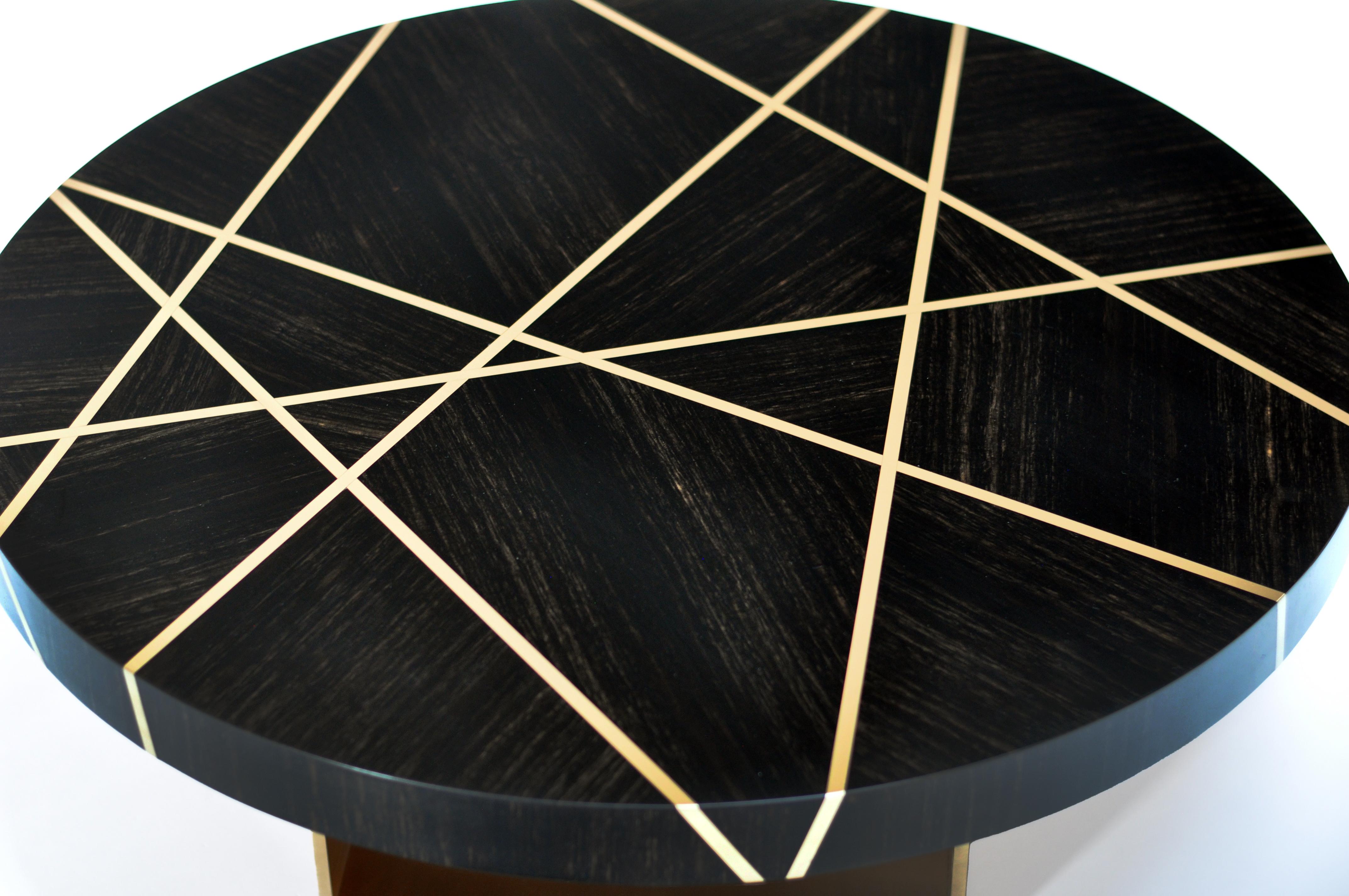 Ray cocktail table in Gabon Ebony with bronze inlay and bronze base is created to be a notable piece. Gabon Ebony is a perfect companion to Bronze. The black wood may have occasional caramel streaks which add to the beauty of the wood and enhance