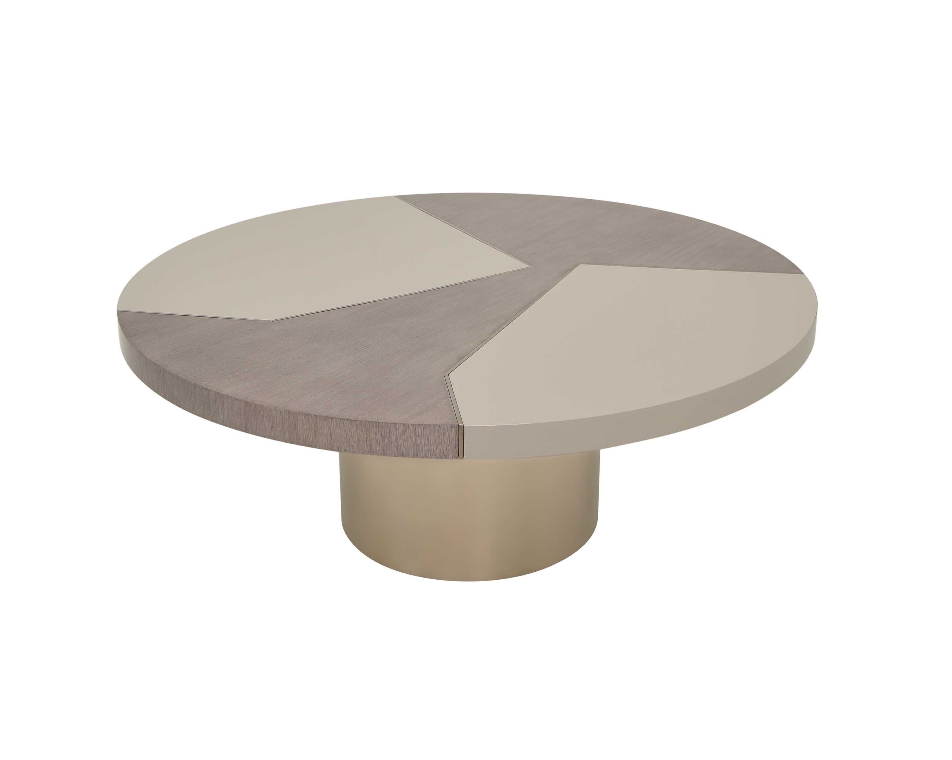 This contemporary center table features a striking round top with a unique geometric design, combining texture with soft tones. Its segmented surface creates a modern, artistic feel that adds visual interest without overwhelming the space. Ideal for