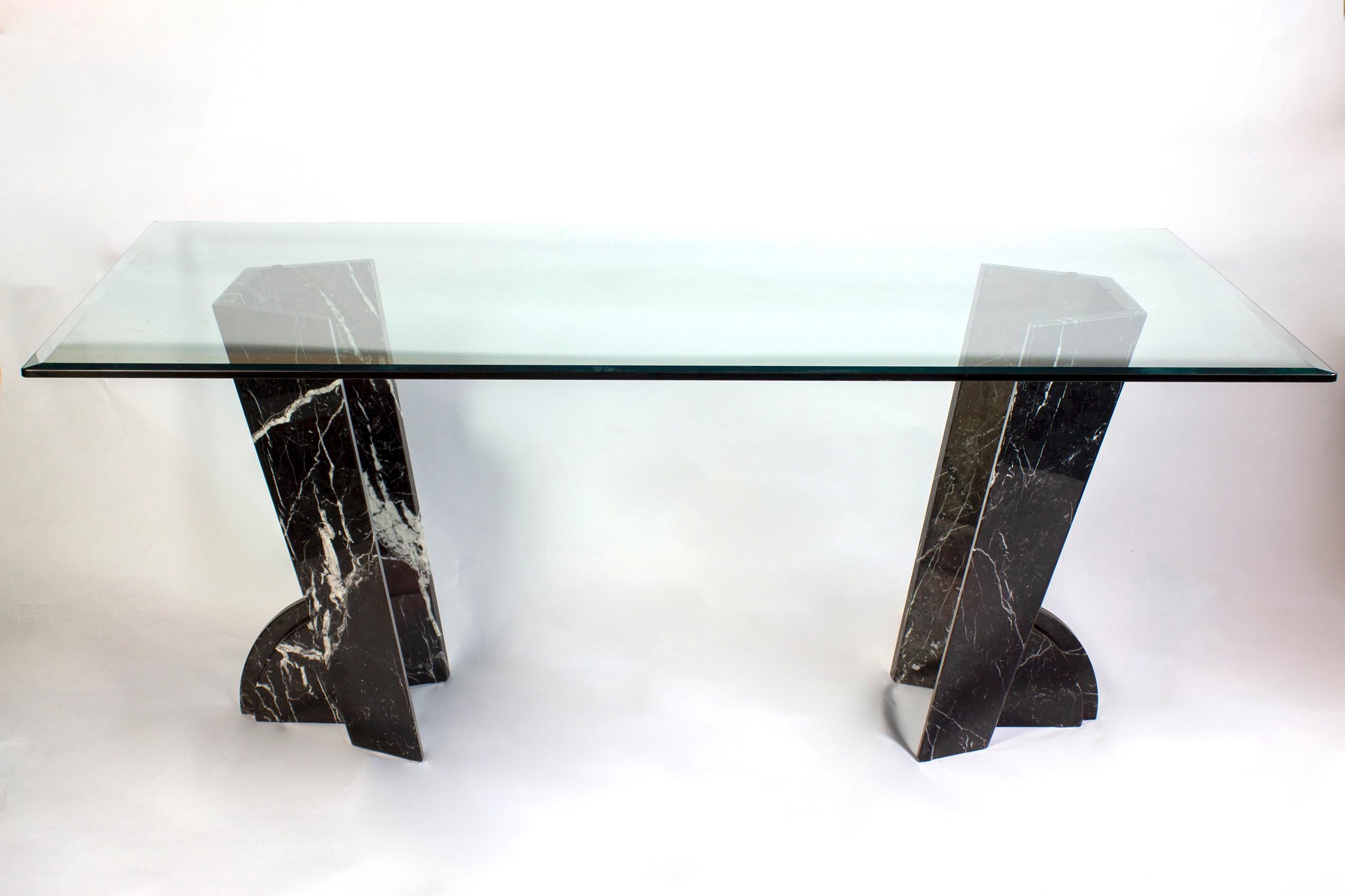 Striking rectangular glass dining or center table.
Elegant design geometric black marble supports.
Excellent original vintage condition.
Can be used as a dining table or a center table.
  