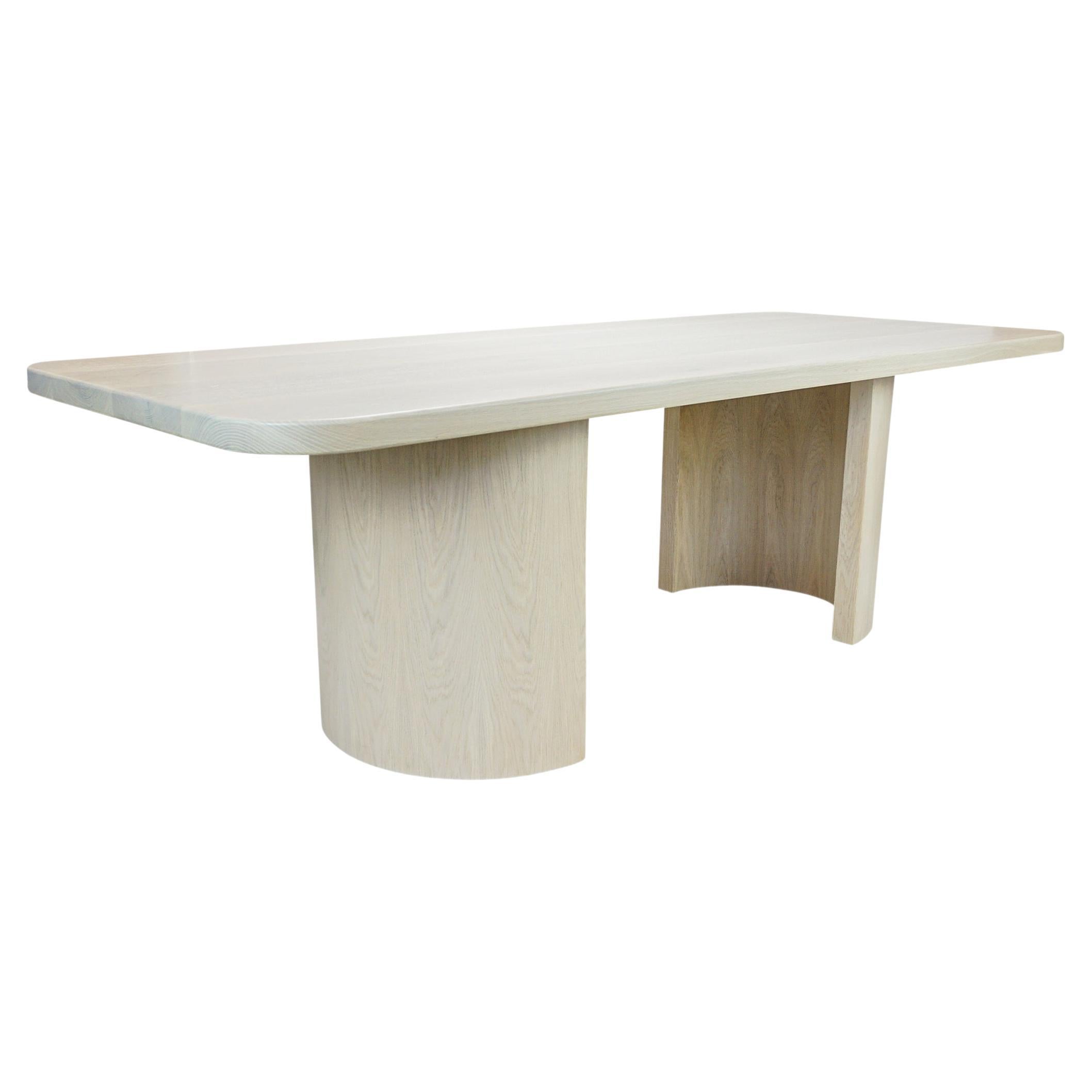 Modern white oak dining table with organic form. Finish shown is cerused / bleach solid white oak. Ask us about customization.

Overall: 96”W x 40”D x 30”H
Inside: 20”W x 11 1/2”D
Clearance from end of table to base: 16