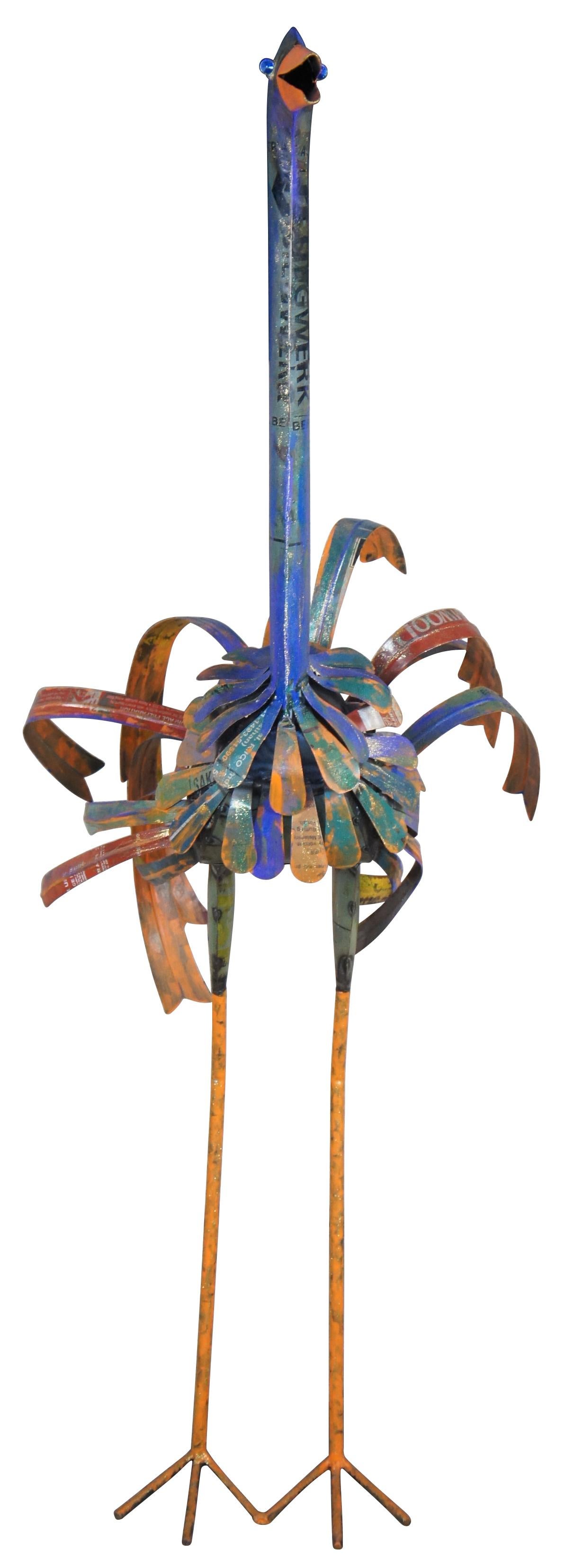 A unique and colorful sculptural crane or ostrich statue. Crafted from reclaimed iron and tin. Features a long purplish neck with orange beak, flowing feathers along the body and wrought iron orange legs and feet. Includes blue jeweled eyes.