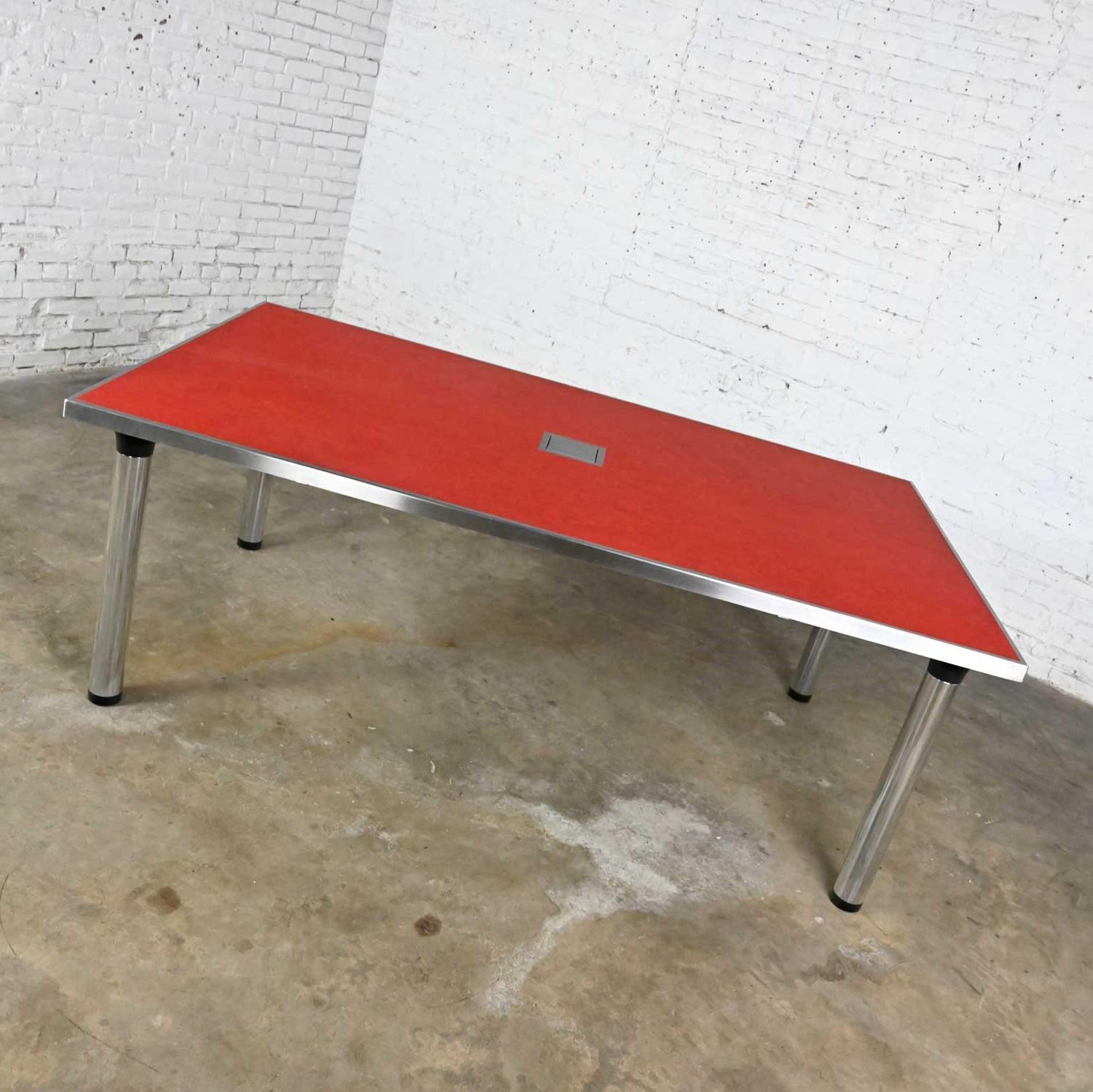 Stunning vintage modern red Marmoleum topped & chrome edged & legged custom-made work or dining table with black accents and center power box with cords. Beautiful condition, keeping in mind that this is vintage and not new so will have signs of use