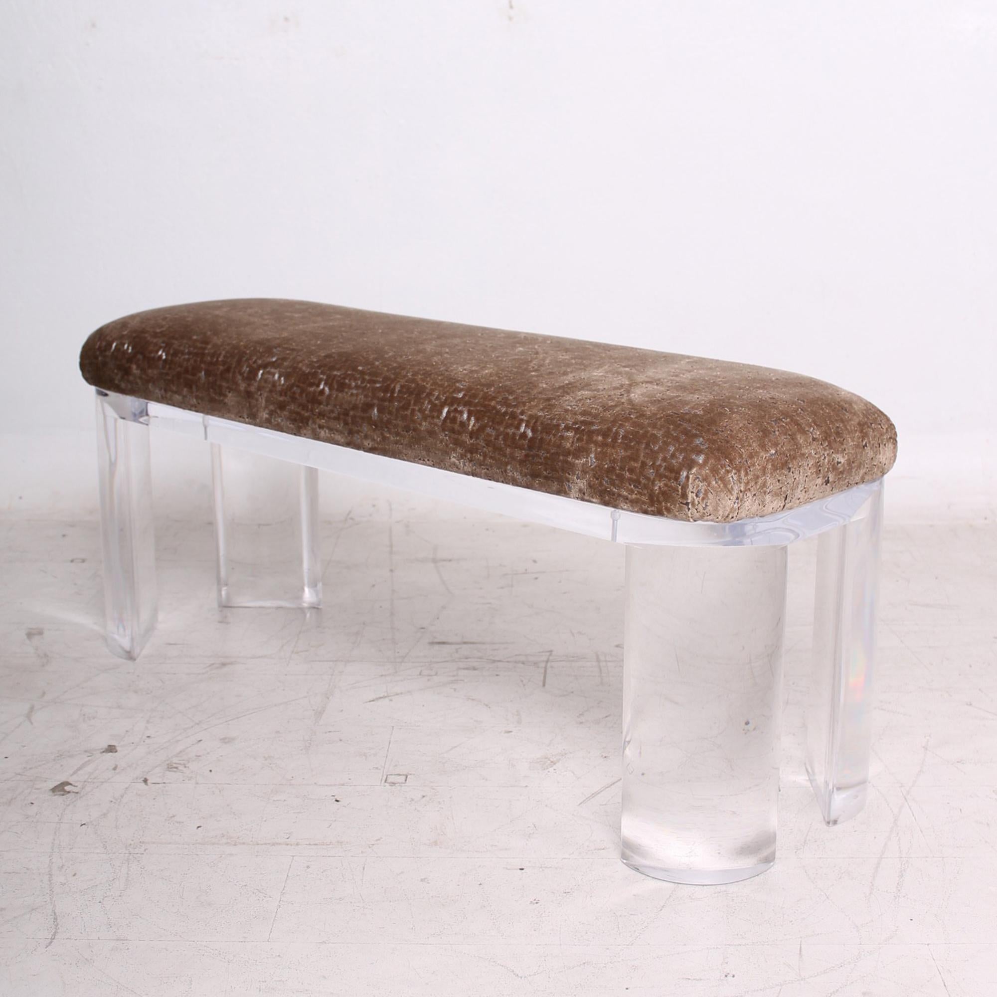 Hollywood Regency modern Lucite bench style of Karl Springer - Charles Hollis Jones Era.
Designed by Carmichael Palm Springs 1980s. Maker stamped.
Thick pronounced round polished lucite legs in golden bronze velvet upholstery
Dimensions: 20 .25 H