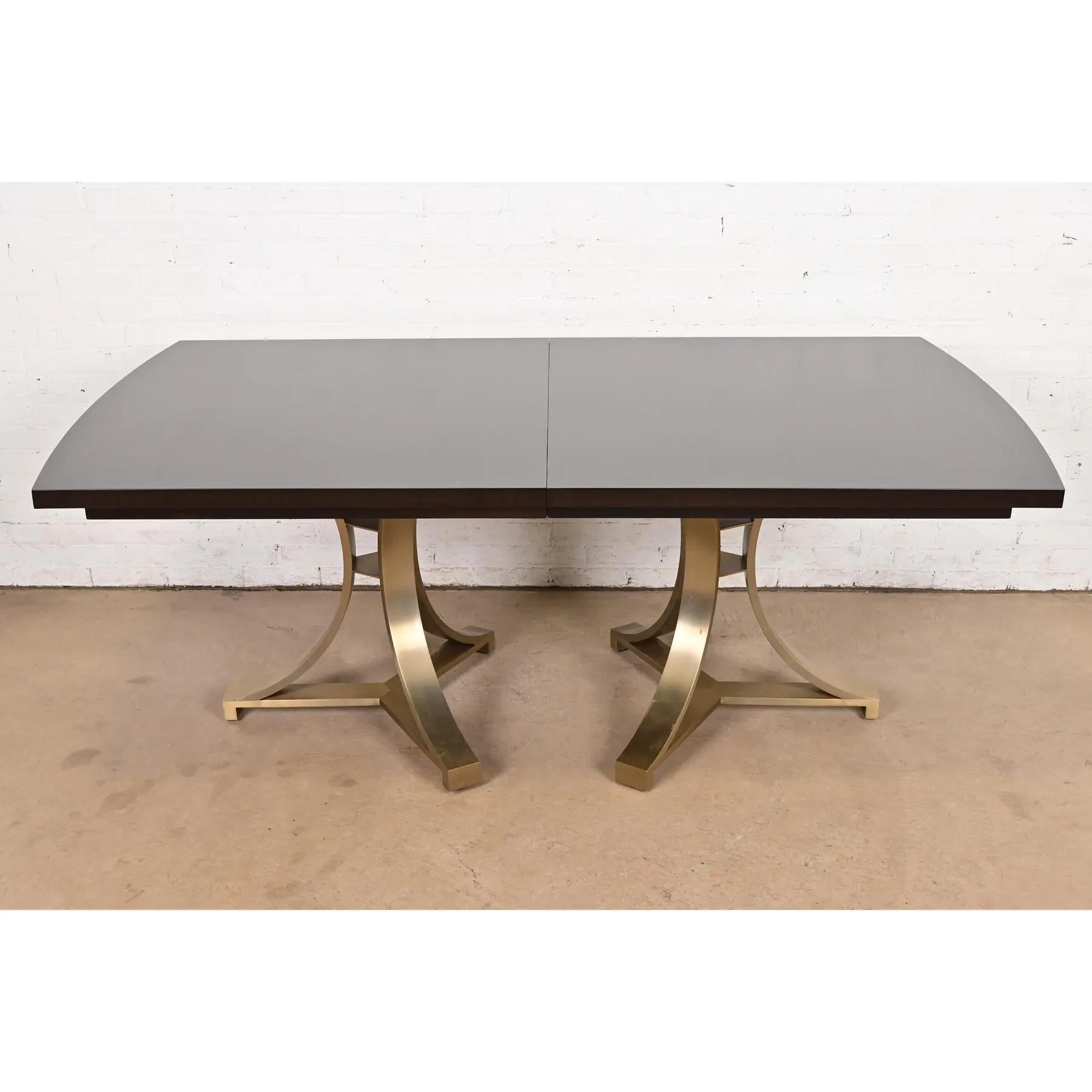 A gorgeous Modern Regency or Hollywood Regency style mahogany and brass double pedestal dining table

USA, Early 21st Century

Gorgeous starburst design mahogany top, with champagne brass finished pedestals. 

Measures: 76
