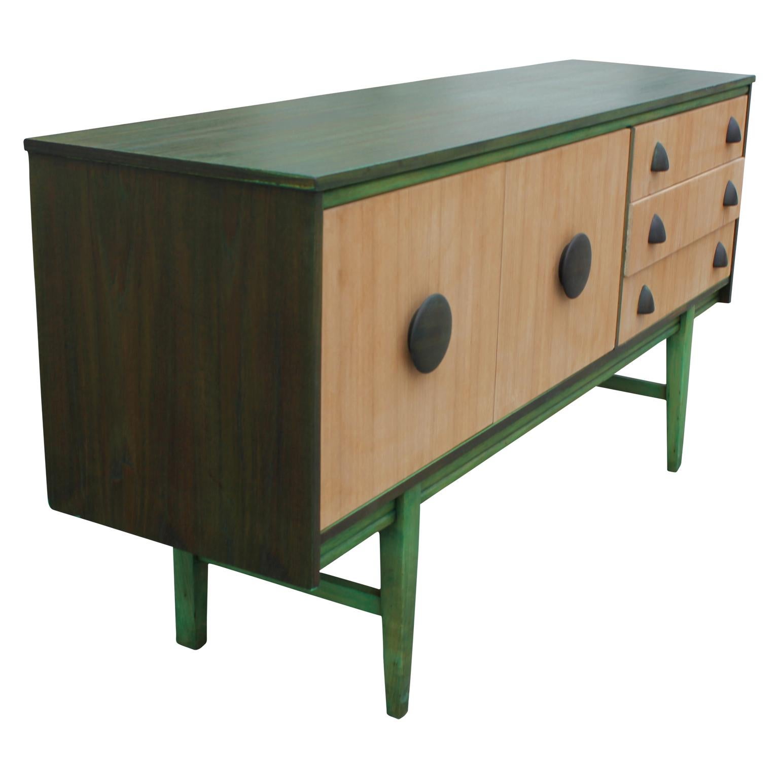 Wonderful modern custom restored Danish style sideboard or credenza. It has a newly completed green dyed finish and wooden handles. This credenza has three drawers and two cabinet doors with one interior shelf.