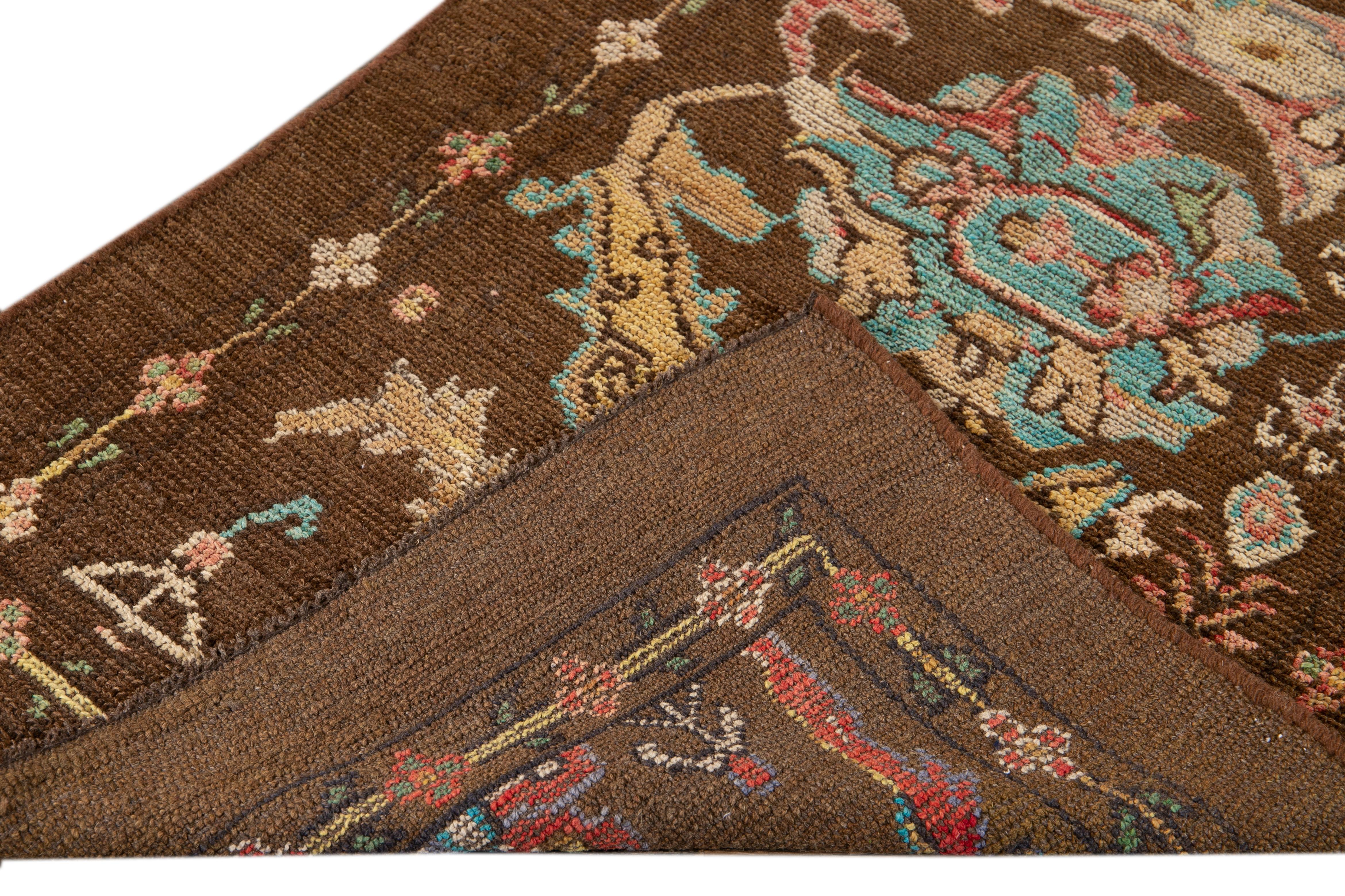 Beautiful modern hand-knotted wool runner with a brown field. This Revival Collection rug has blue, pink, yellow, and beige accents all-over a gorgeous geometric Floral design.

This runner measures 2'11
