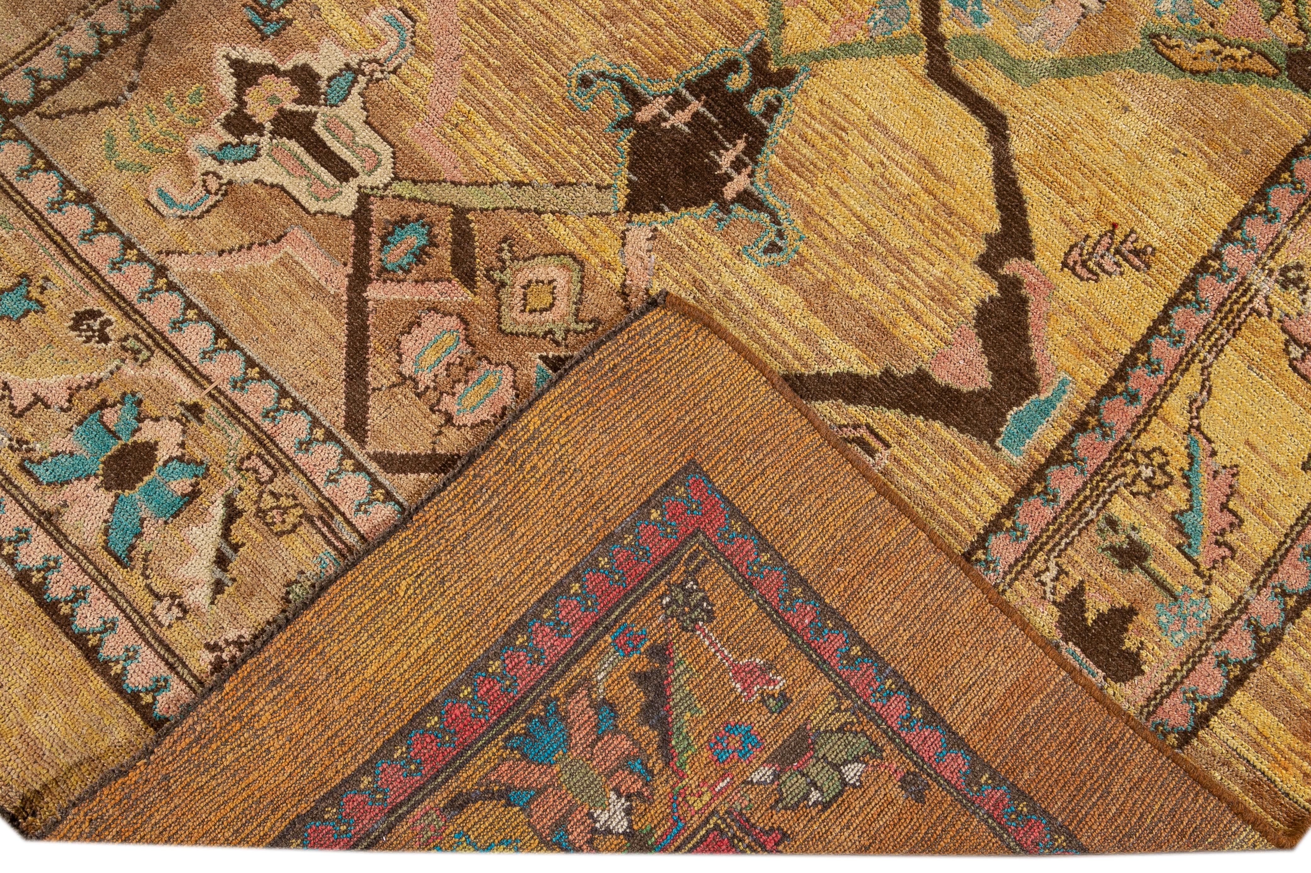 Beautiful modern hand-knotted wool rug with a yellow field. This Revival Collection rug has blue, pink, brown, and green accents all-over a gorgeous geometric Botanical Floral design.

This rug measures 6'3