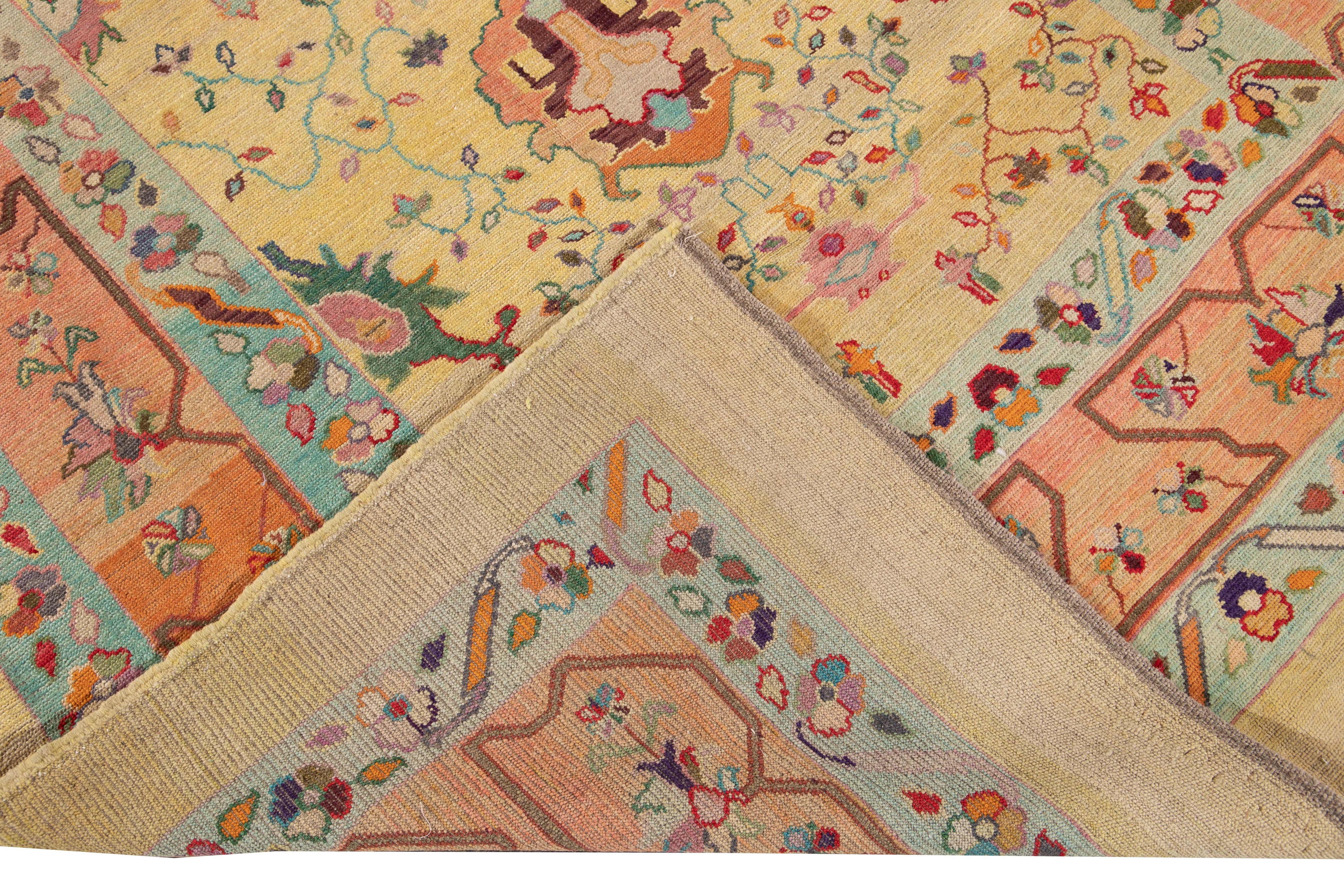 Beautiful modern hand-knotted wool rug with yellow field. This Revival Collection rug has an orange and blue frame and bright multi-color accents all-over a gorgeous geometric Floral design.

This rug measures 6'4
