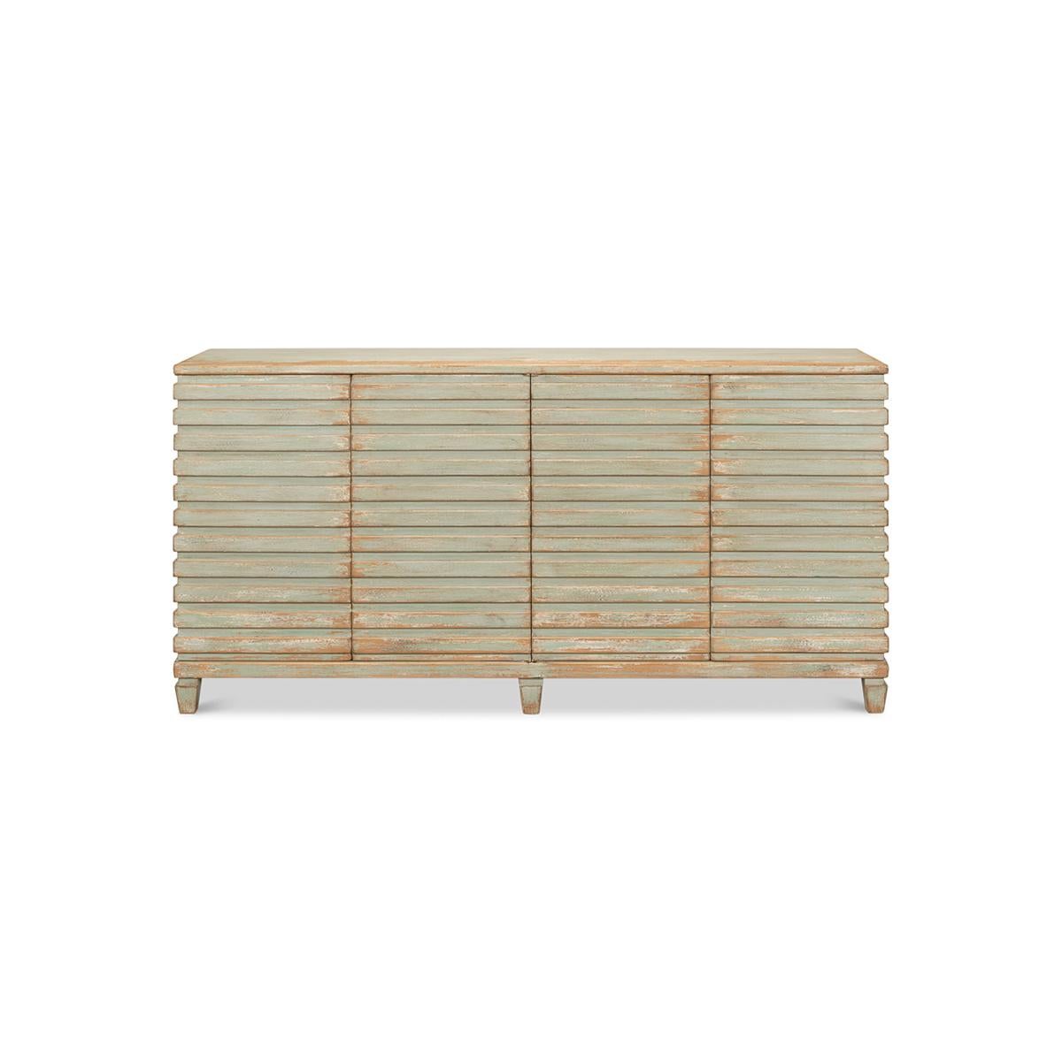 Modern ribbed sideboard of pine in an antiqued hand-rubbed sage green finish. The buffet cabinet with four doors and interior shelves and a geometric ribbed design that wraps around each side, with square tapered legs.

Dimensions: 72