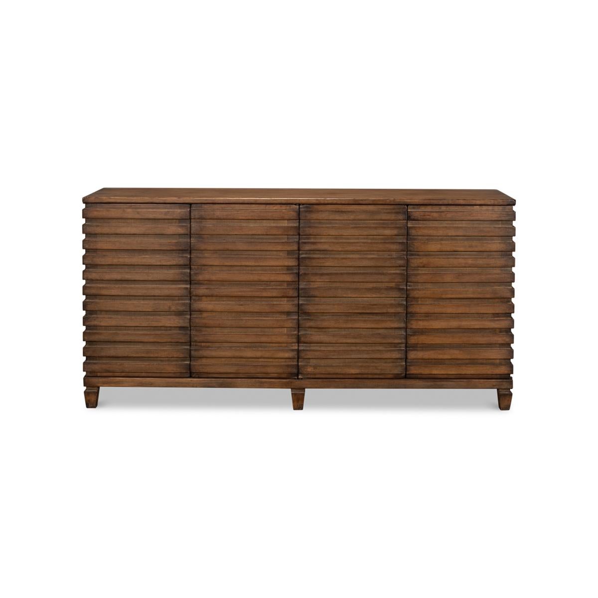 Modern Ribbed sideboard of pine in a mahogany-stained finish. The buffet cabinet with four doors and interior shelves and a geometric ribbed design that wraps around each side, with square tapered legs.

Dimensions: 72