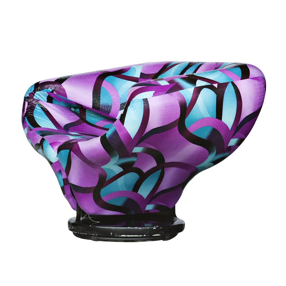 Ribbon chair in the style of Pierre Paulin

Multicolored faux snakeskin upholstery
 
Black circular wooden pedestal base.

   