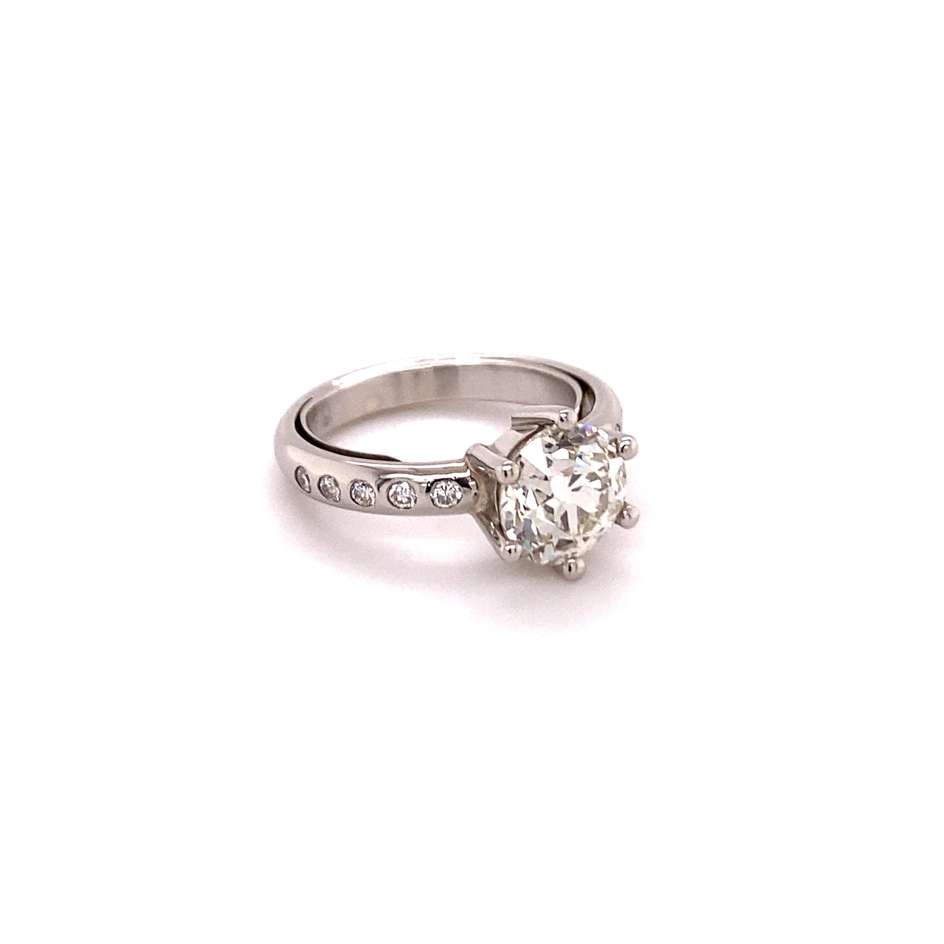 Modern ring manufactured in platinum 950. Set in six prongs with one old European-cut diamond of 1.70 ct. The diamond is of slightly tinted colour (J/K after GIA standards) and of si1 clarity. 

The shoulders of the shank are elegantly bezel set