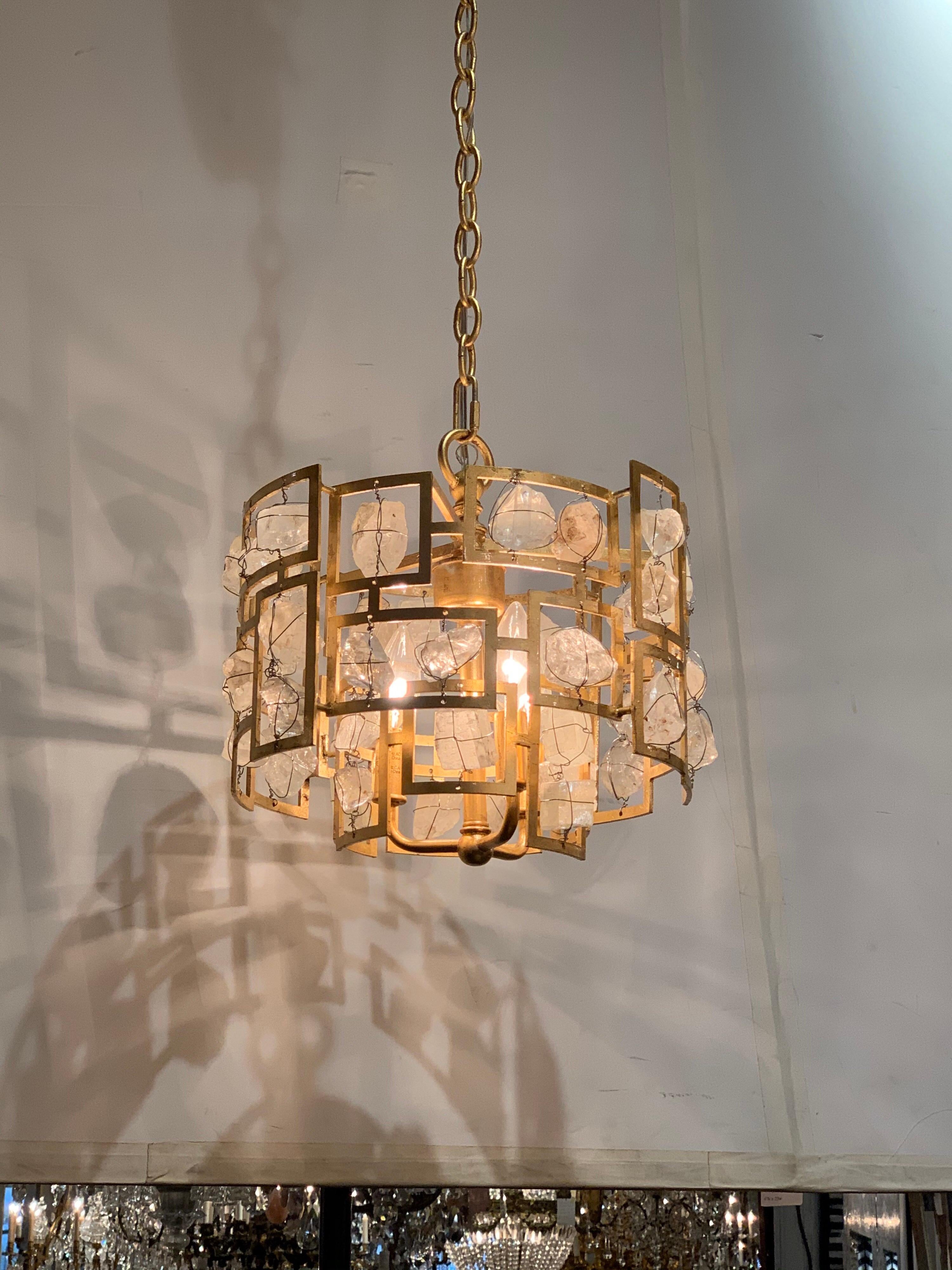 Beautiful modern rock crystal and gilt metal chandelier. Very fine gilt finish on the metal and lovely rock crystals. A very unique piece!