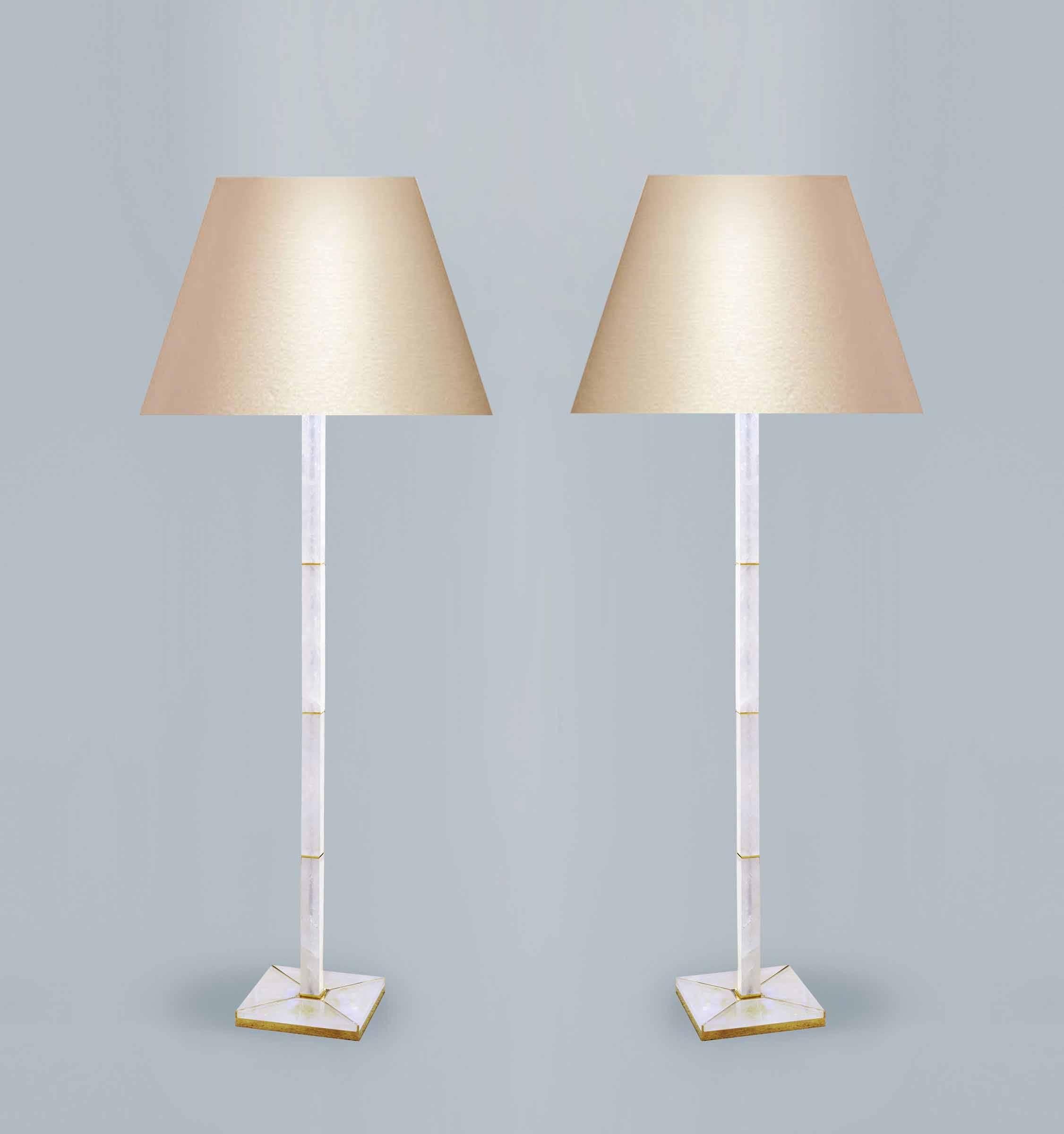 Pair of fine carved square column rock crystal floor lamps with a gilt metal base, created by Phoenix Gallery, NYC.
(Lampshade not included).
 