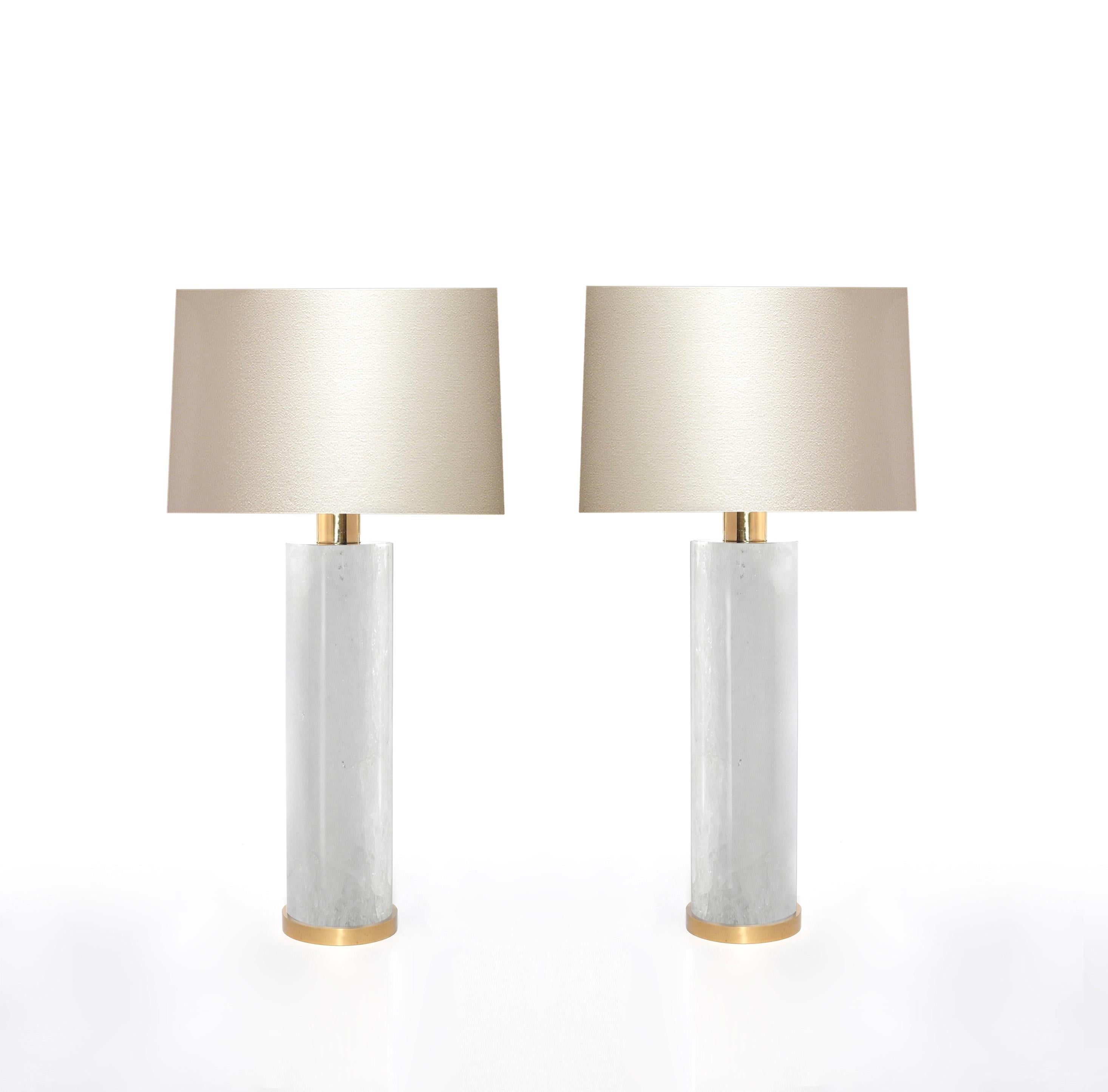 Pair of cylindrical form of rock crystal quartz lamps with polished brass bases. Created by Phoenix Gallery, NYC.
To the rock crystal: 17.5