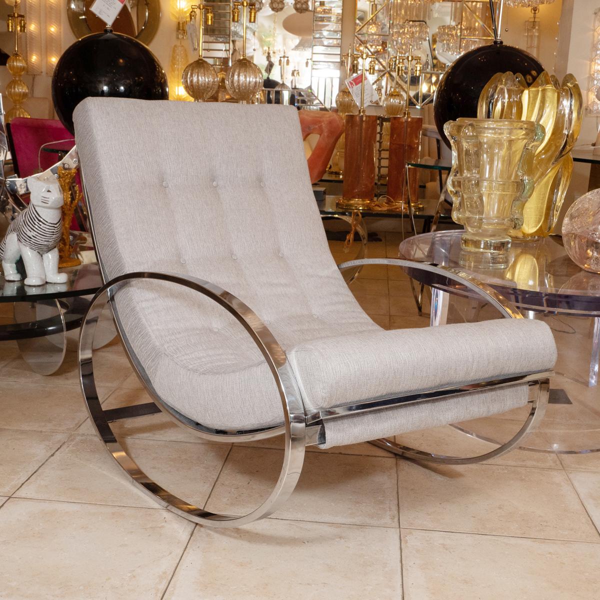 Modern rocking chair and ottoman with chrome details.

Ottoman: 25.5