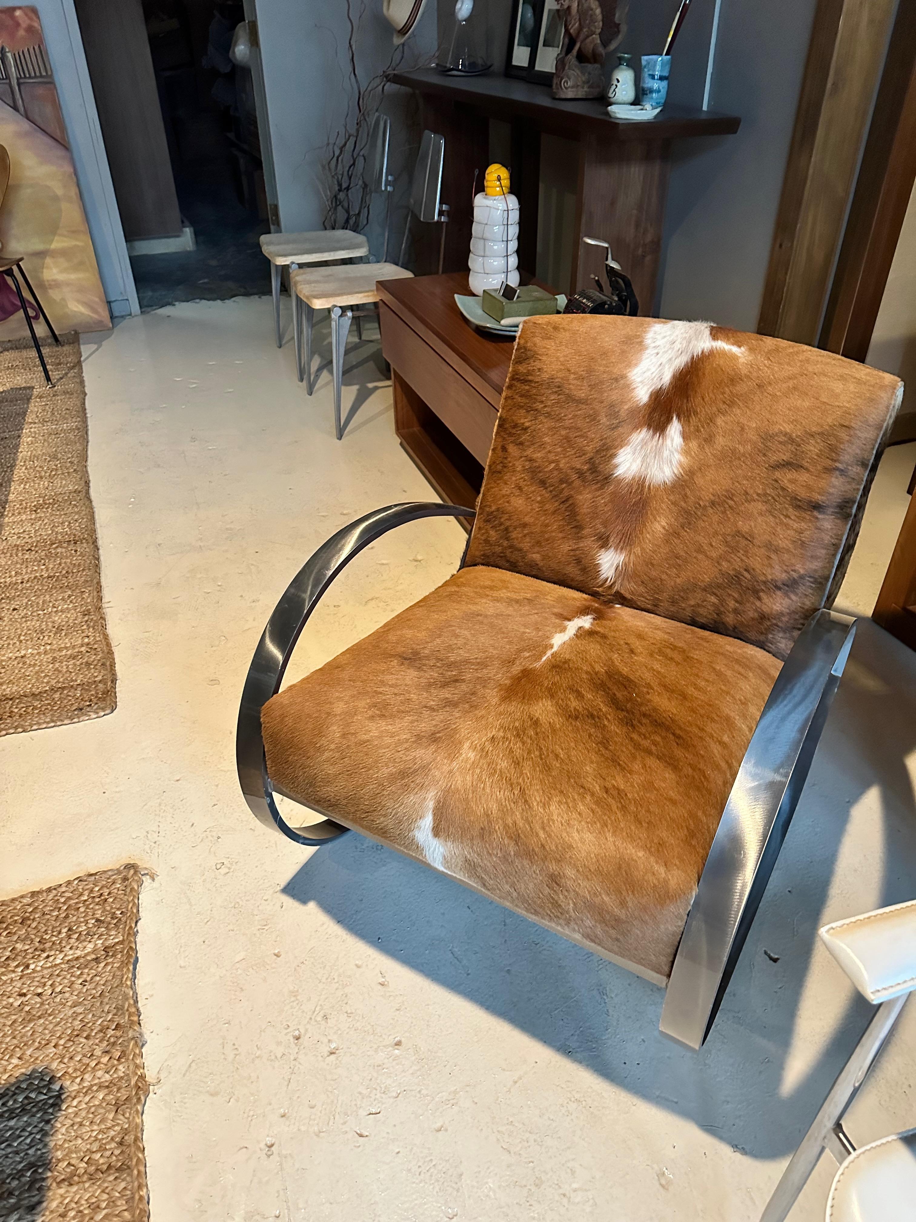 beautiful one off modern steel framed rocking chair in cowhide upholstery. In the deco/ modern styling on Mies van der Rohe or Eileen Gray. wonderful combination of vinatge and modern .