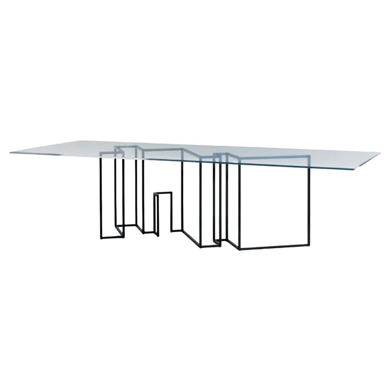 Rectangular dining table designed by Ron Gilad for Dilmos Edizioni.
The table has a lacquered iron base and 22 mm thick extra light glass top with round corners. The design of the base represents the floor plan of the designer's New York apartment.