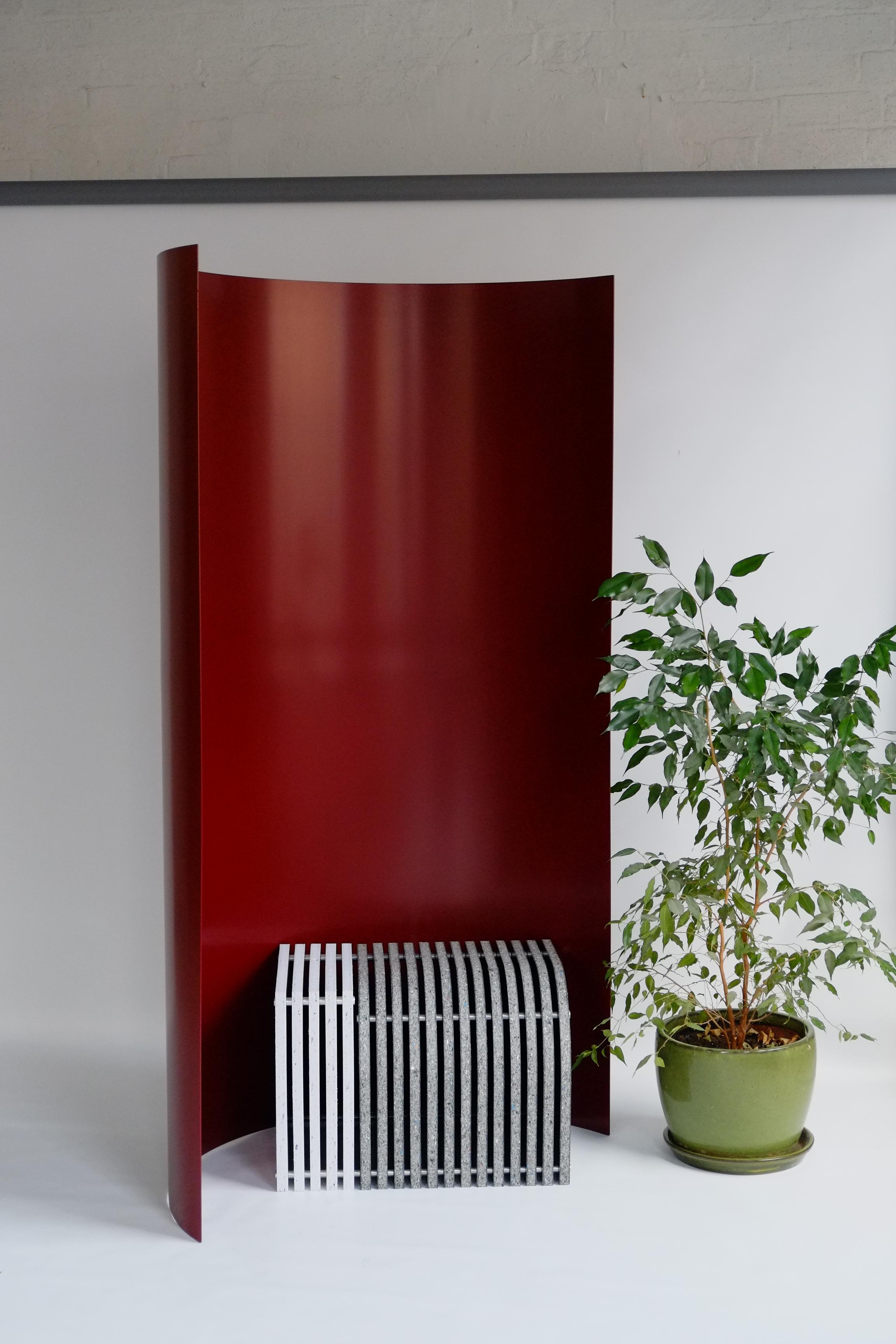 The Gray screen is a freestanding room divider named after the iconic modernist architect-designer Eileen Gray, a lover of screens. The large powder-coated aluminium curves introduce a mass of vibrant colour into an interior. The screen can be used