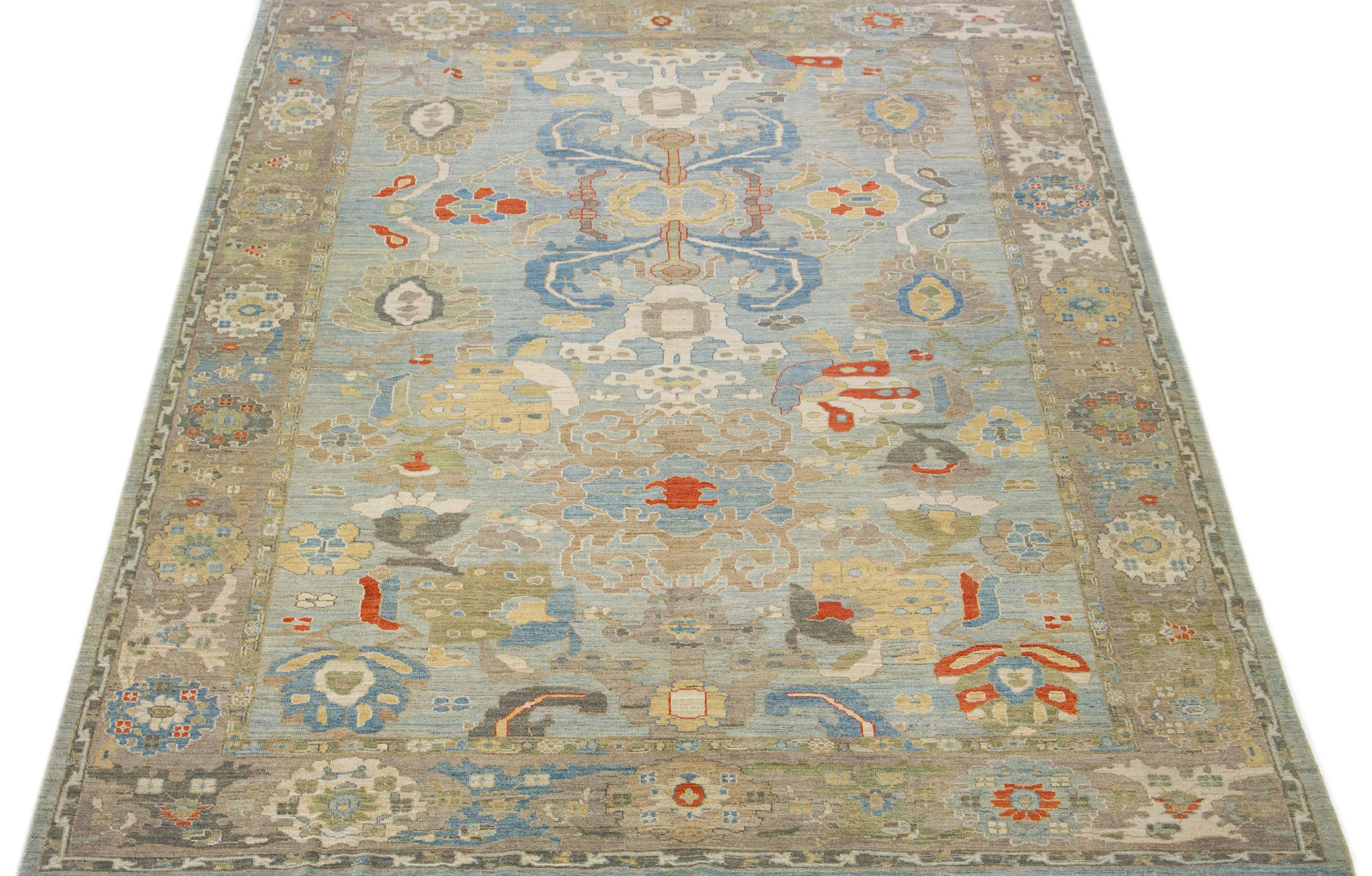 This contemporary take on the traditional Sultanabad style is showcased in an exquisite hand-knotted wool rug with a striking light blue color. An intricately designed frame accentuates its all-over floral motif, adorned with multicolored accents