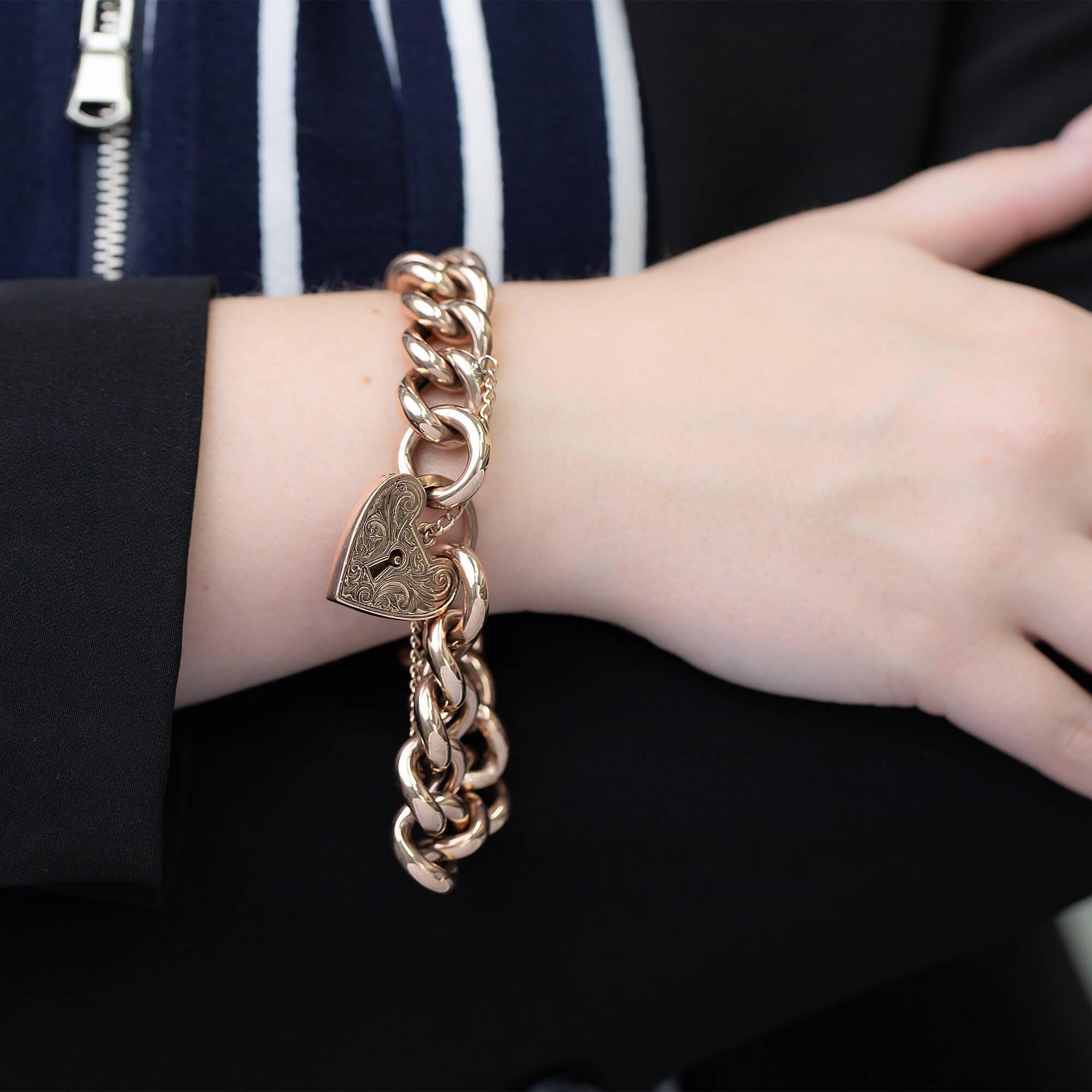 This beautiful open link bracelet is crafted in rose gold featuring a decorative engraved heart padlock and fitted with a safety chain. Each link is stamped with the 9ct hallmark.

Metal: 9k rose gold - XRF tested
Weight: 53.15 grams
Measurements: