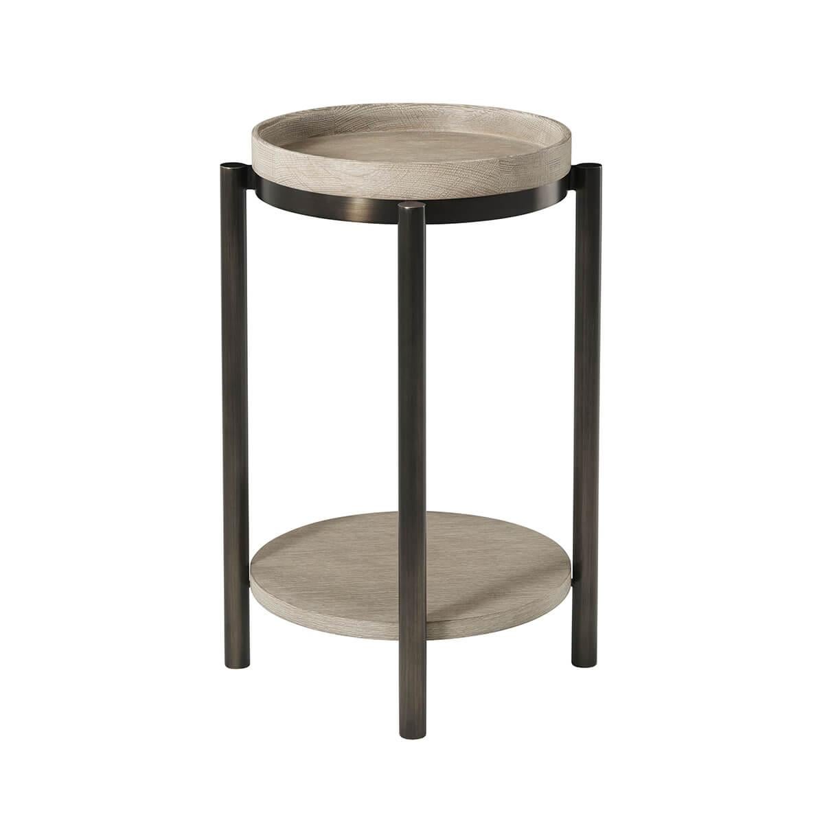 With an oak tray top and contrasting bronzed metal legs, the round side table can also be used as a drink table. With an intensive multi-step hand finish on this piece to bring out the natural wood grain of the wood of our light grey oak