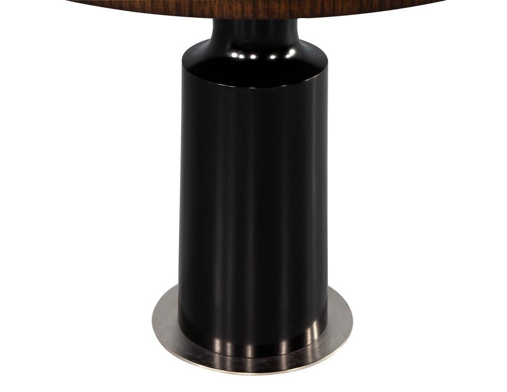 Modern Round Center Table in Walnut. Hand crafted and newly made in Canada by the artisans at Carrocel. The perfect blend of modern styling with a mid-century heart. Featuring a sleek sculpted high gloss black pedestal stand with brushed