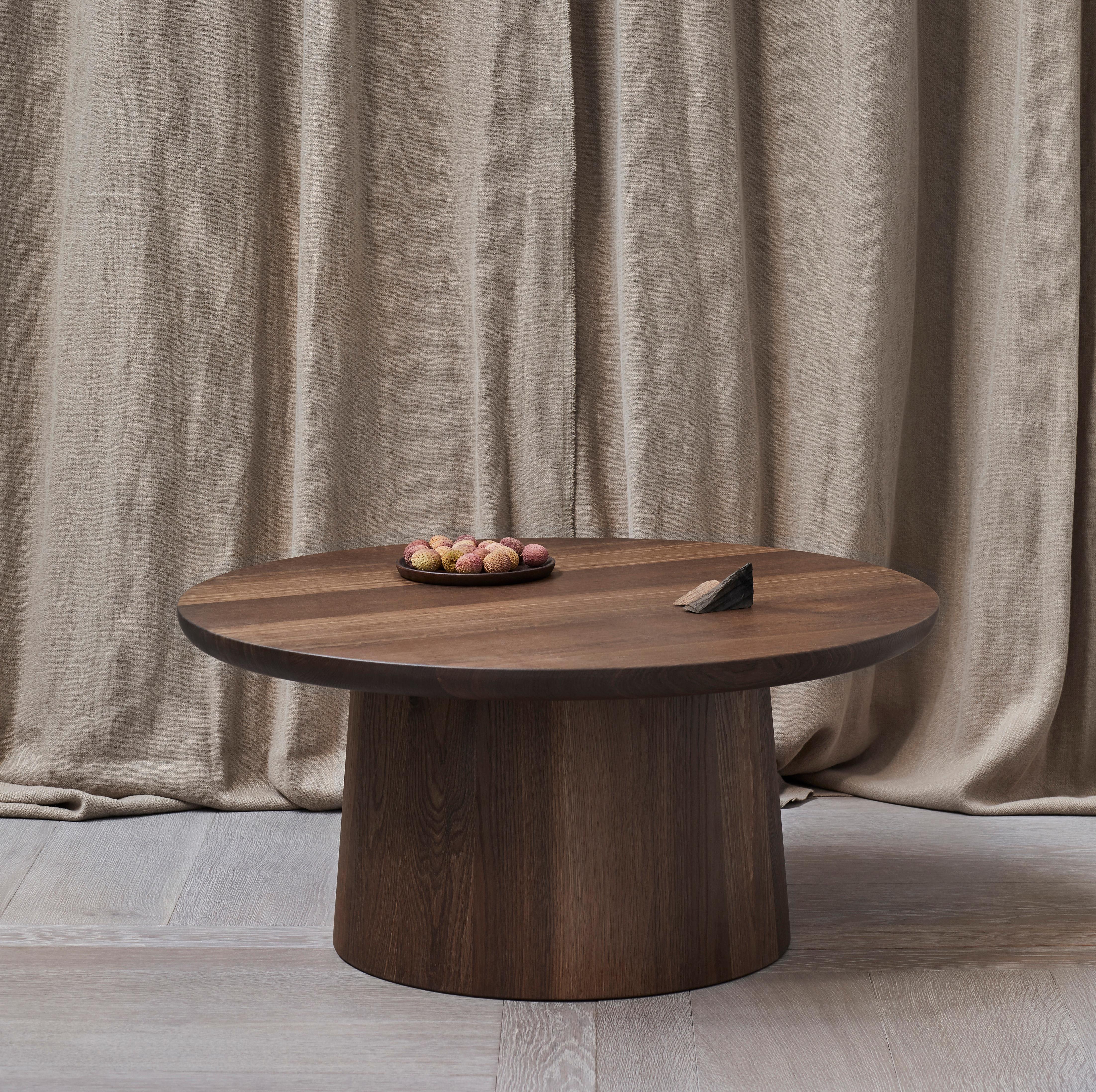 This handmade round pedestal table features a solid wood coopered base and curved edge solid wood top. Edward Collinson hand selects all their wood from English suppliers, the simplicity of the design is typical of Edwards work. Each base is made