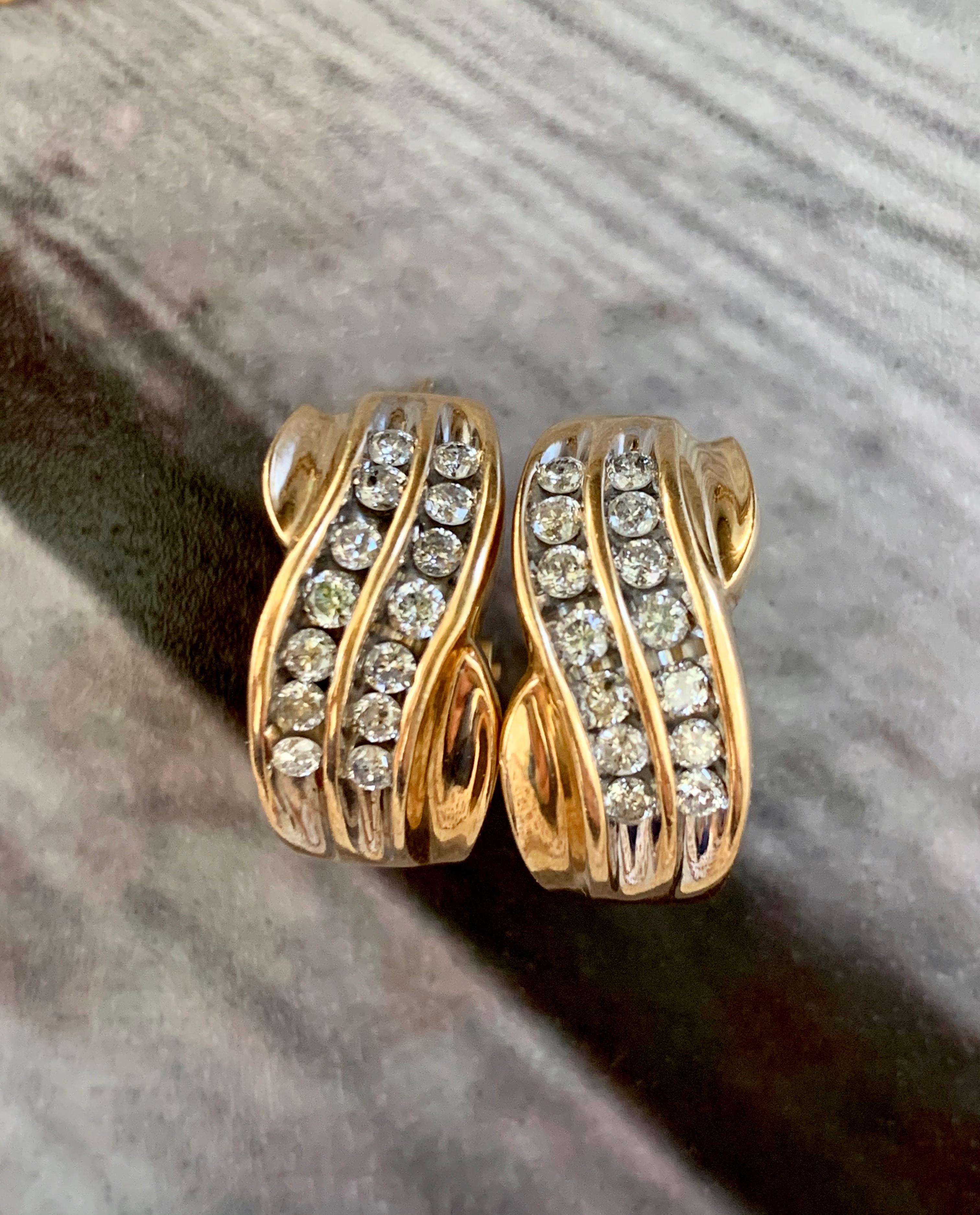 These lovely earrings are a nice twist on the traditional hoop earrings.  They feature 28 - 2.5mm brilliant cut Diamonds with a total weight of approximately 1.5ctw.  Grades are I(1)-I(2) for clarity and H for color.
the diamonds are set in two wavy