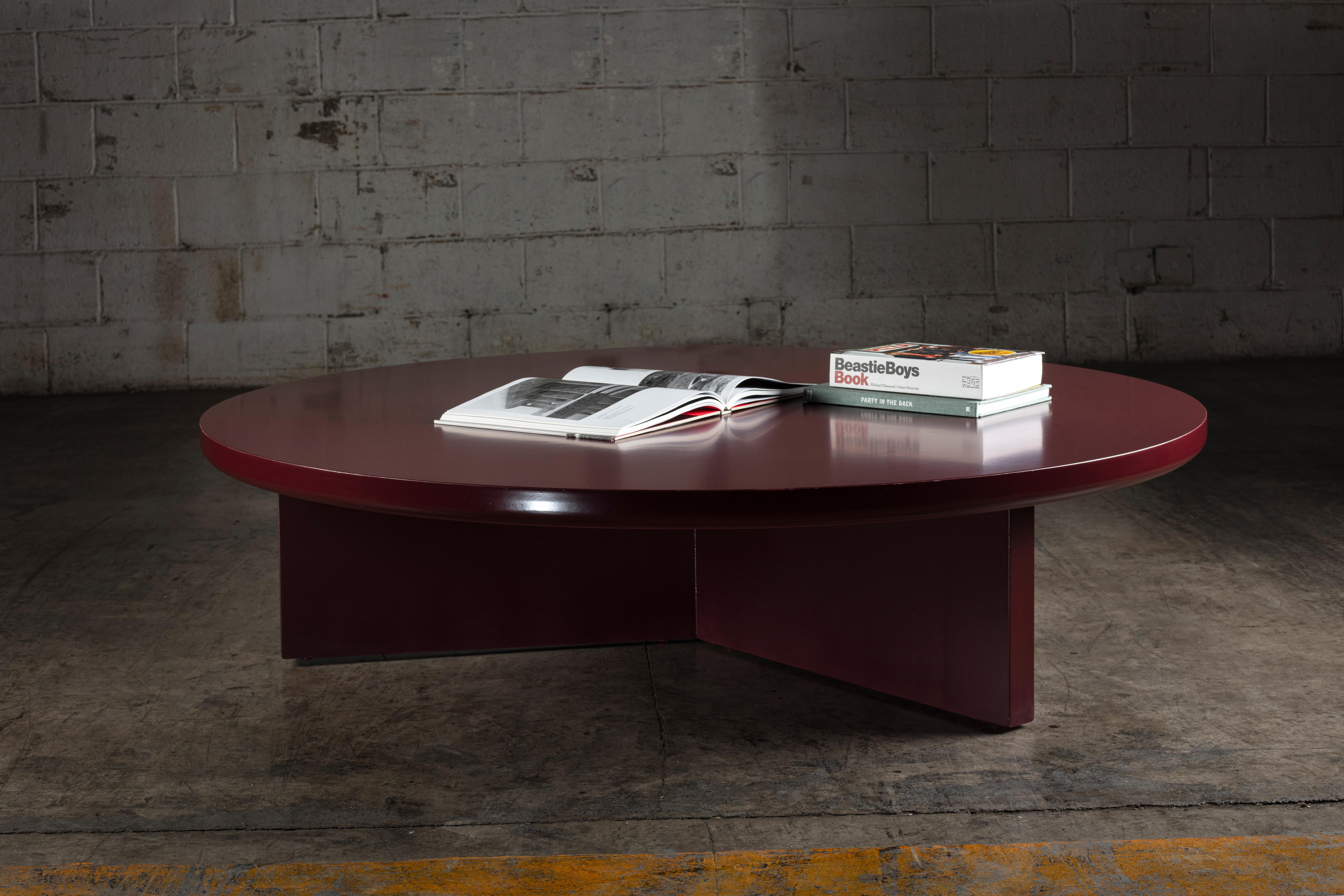 Modern round deep dark red coffee table.