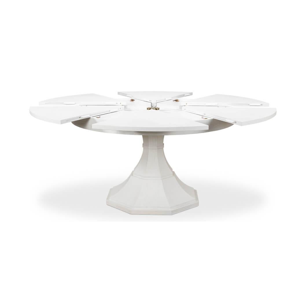Modern round dining table modern round white painted oak veneered extension dining table with self-storing leaves, on a tapered column form pedestal base.

Open dimensions: 70