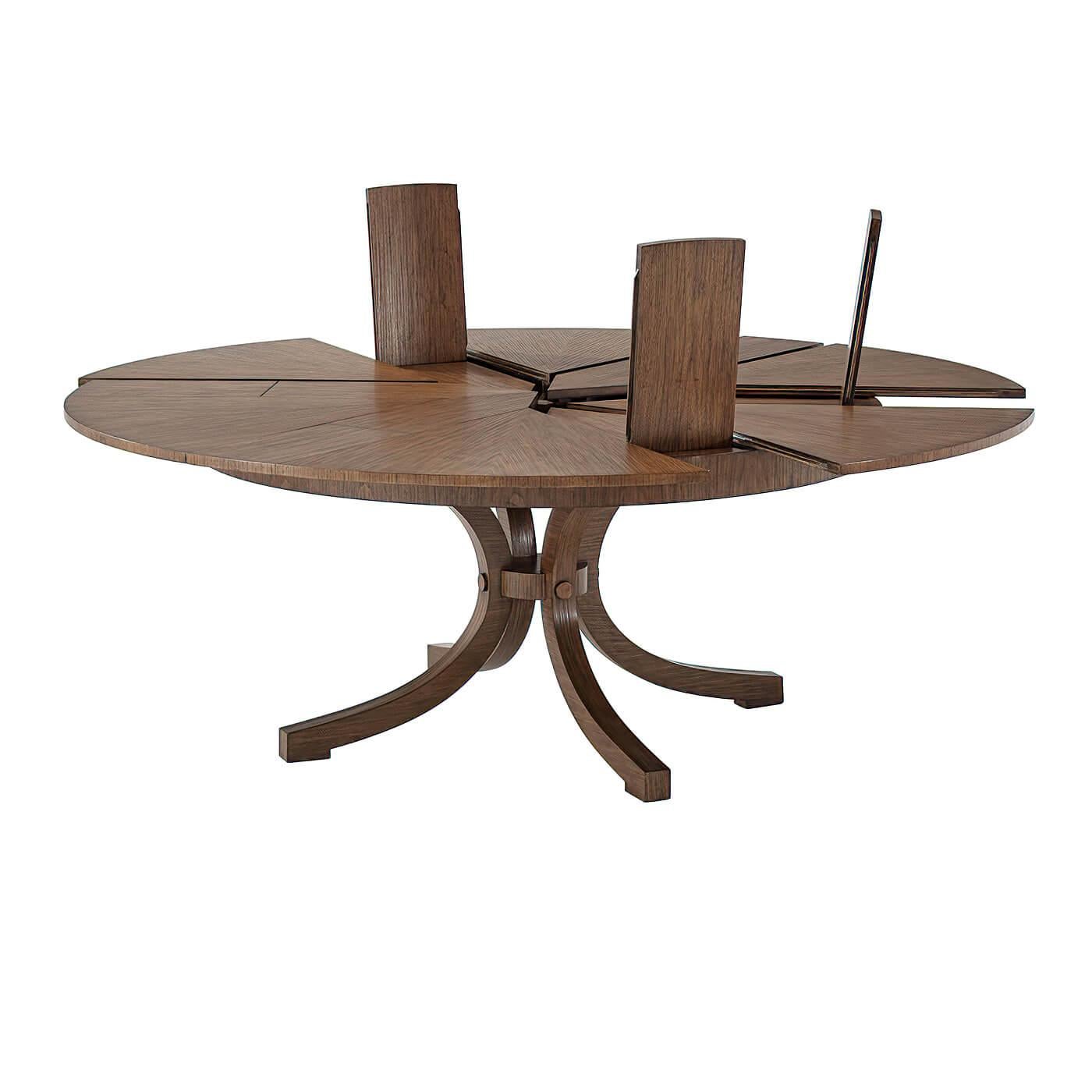 This is a unique European-designed round dining table with six pullout sections and six self-storing fold-out leaves. The table is finished with a warm hewn hazel finish. With 12 leaves, this table seats seven when closed and nine when open.

Open