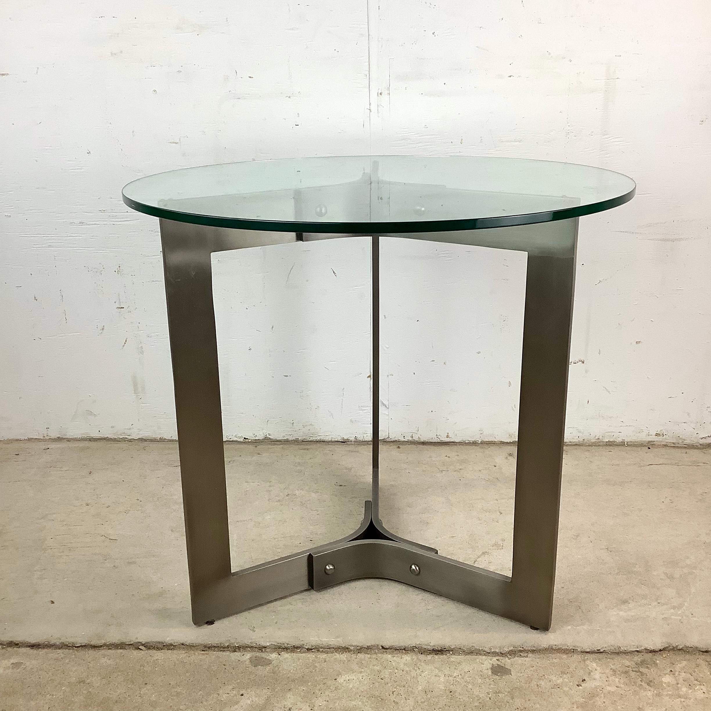 Inspired by an italian modern approach to design, this end table merges material honesty with architectural grace. The base, forged in steel, rises in a play of form and balance to support a clear round glass top that seems to float effortlessly