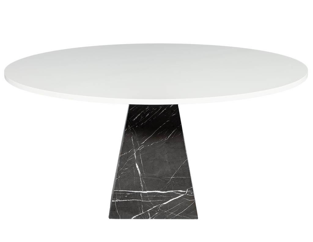 Modern round marble dining table. Round wood top finished in a white satin. Featuring a clean cut grey and black marble pedestal with white details.
Price includes complimentary curb side delivery to the continental USA.