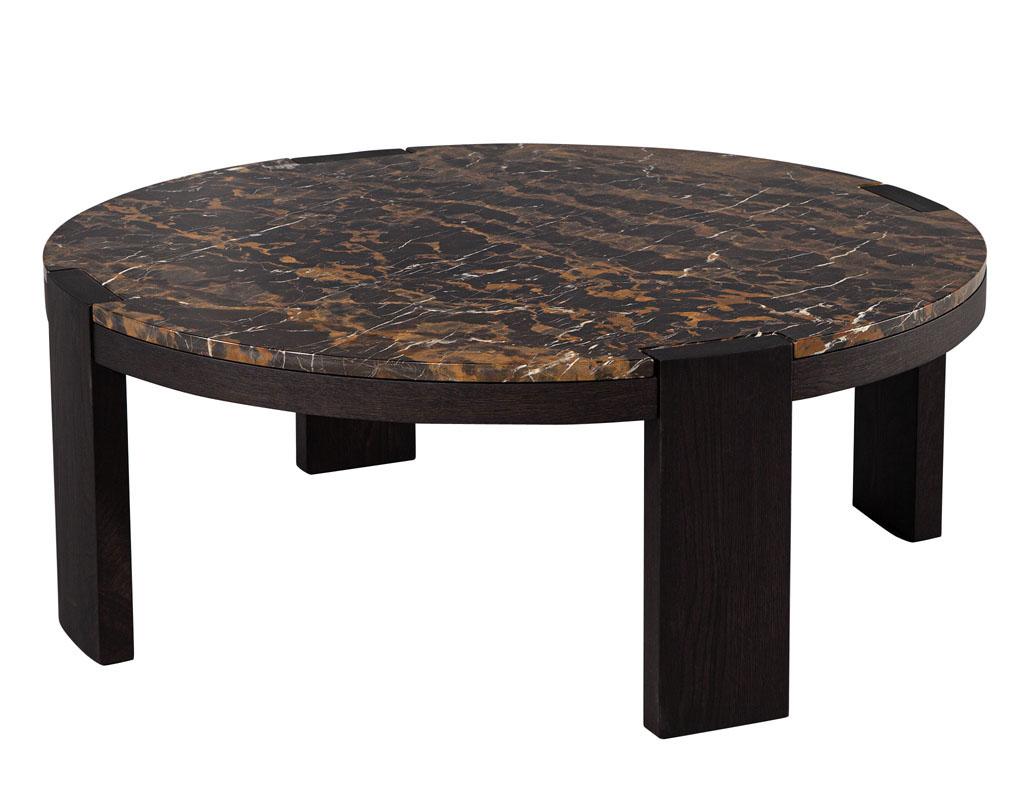 Modern Round Marble Top Coffee Table. Sleek modern styling with solid wood frame in a dark espresso satin finish. Completed with an incredibly detailed marble stone top, perfectly cut to integrate into the framed pillars creating a clean set-in