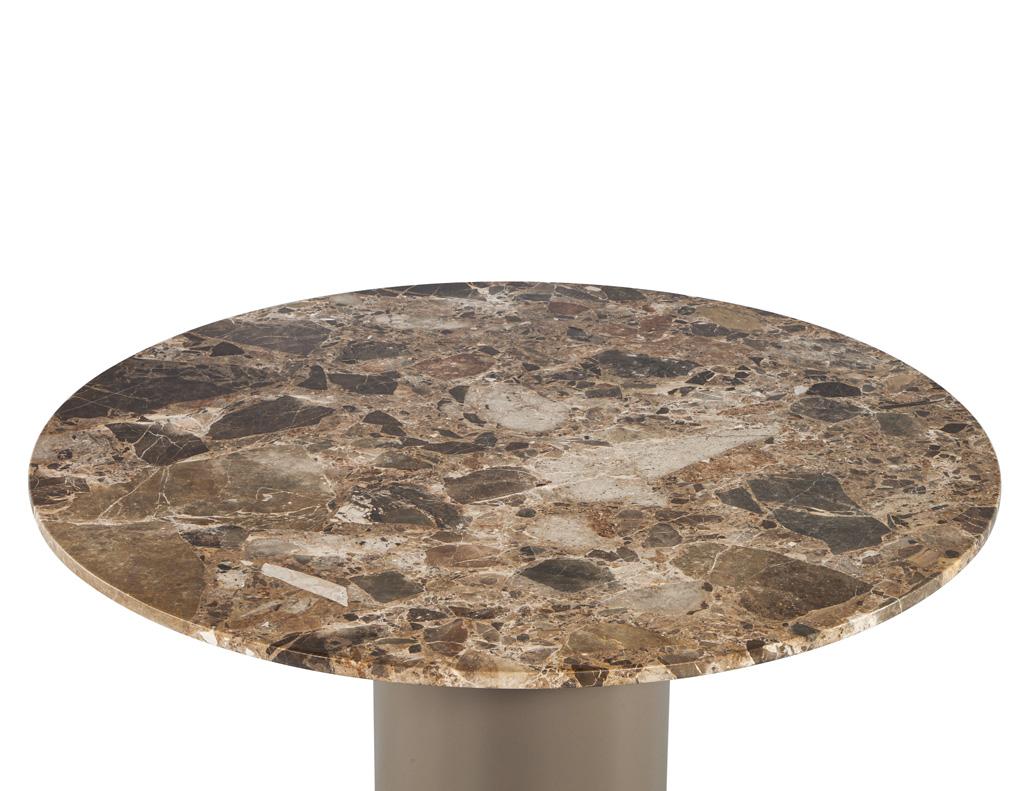 Introducing our exquisite vintage modern round marble top dining table, a stunning centerpiece that beautifully marries form and function. Crafted with a beautiful marble top featuring unique veining structures in earthy tones, this table is a