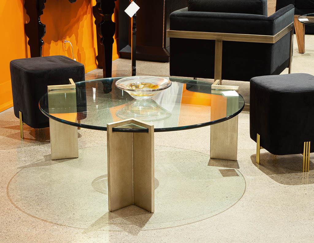 Modern round metal and glass coffee table by Pace Collection. Iconic Mid-Century Modern design, America, circa 1960s. Masterfully restored with a gold leaf antiquing finish on the metal supports. Unique design, glass slides into the metal stands and