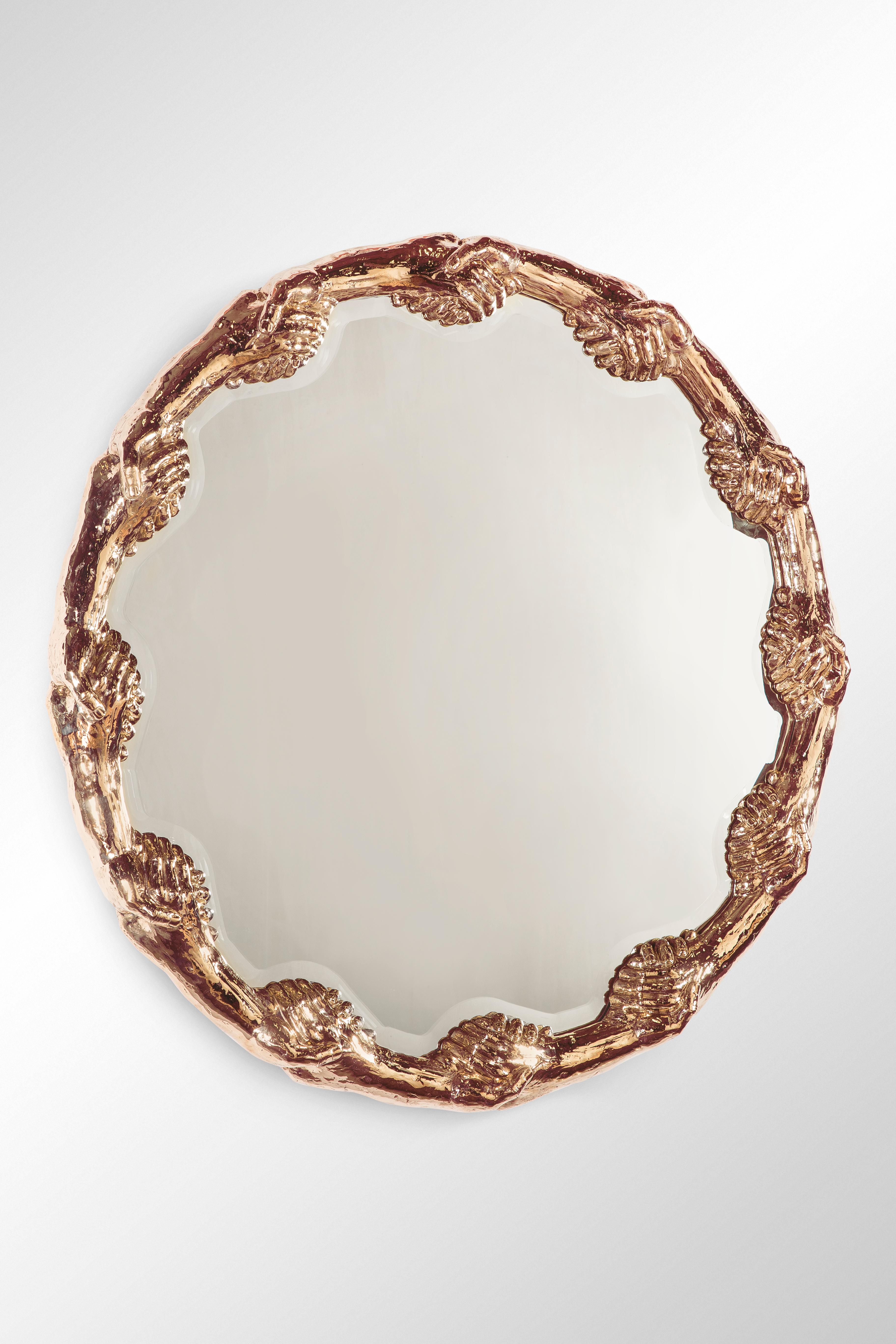 Mirror made of polished bronze, which represents a circle of hands gripping each other in endless promises and their consequences.
This unique and limited edition piece was presented for the first time on the occasion of Studio Job's 