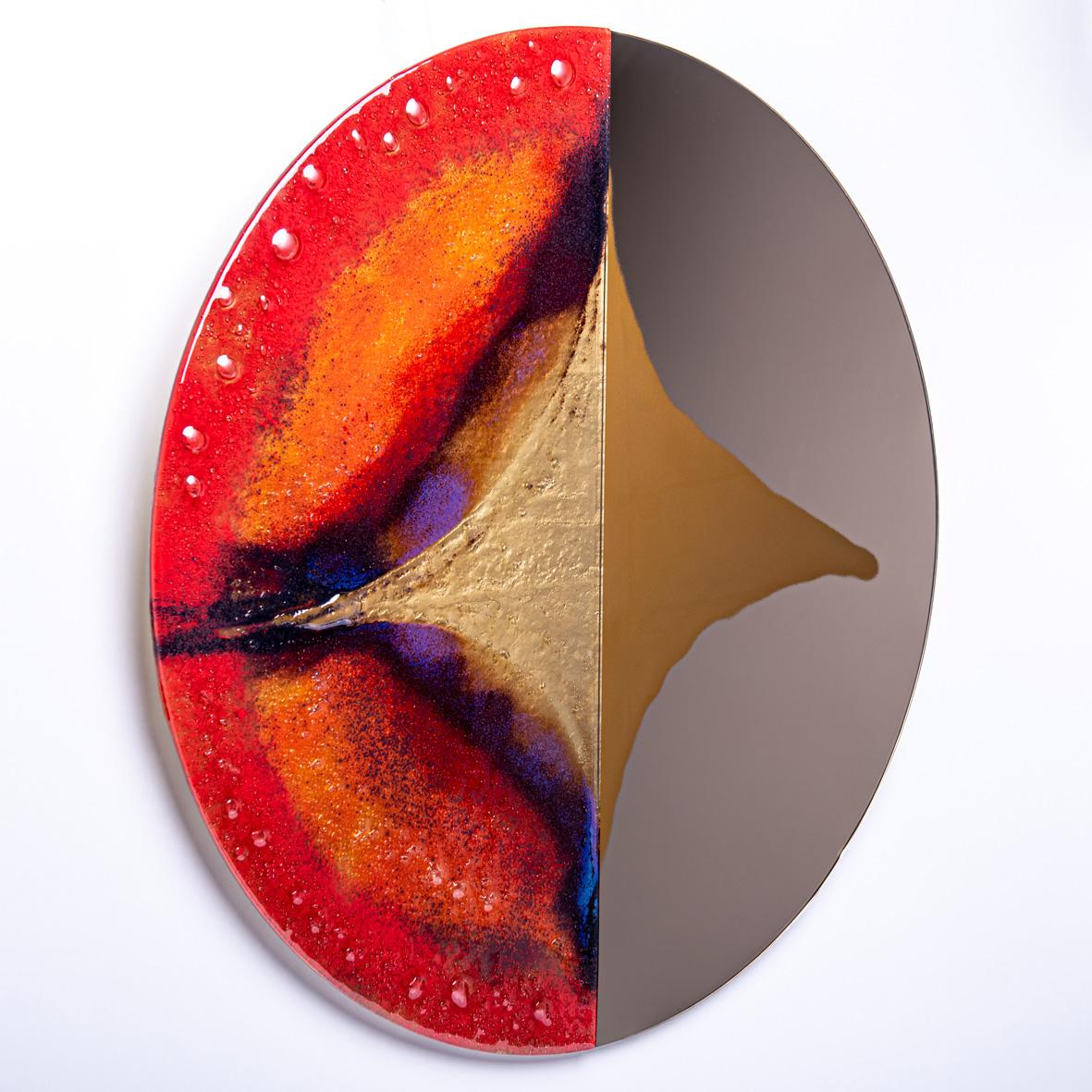 Contemporary and modern round mirror with Murano kind handmade glass colored using metal oxides in red, brown, cobalt and liquid metal. Limited collection signed by Edith Baranska showed for the first time in Milan, 2019. Each piece is unique and a