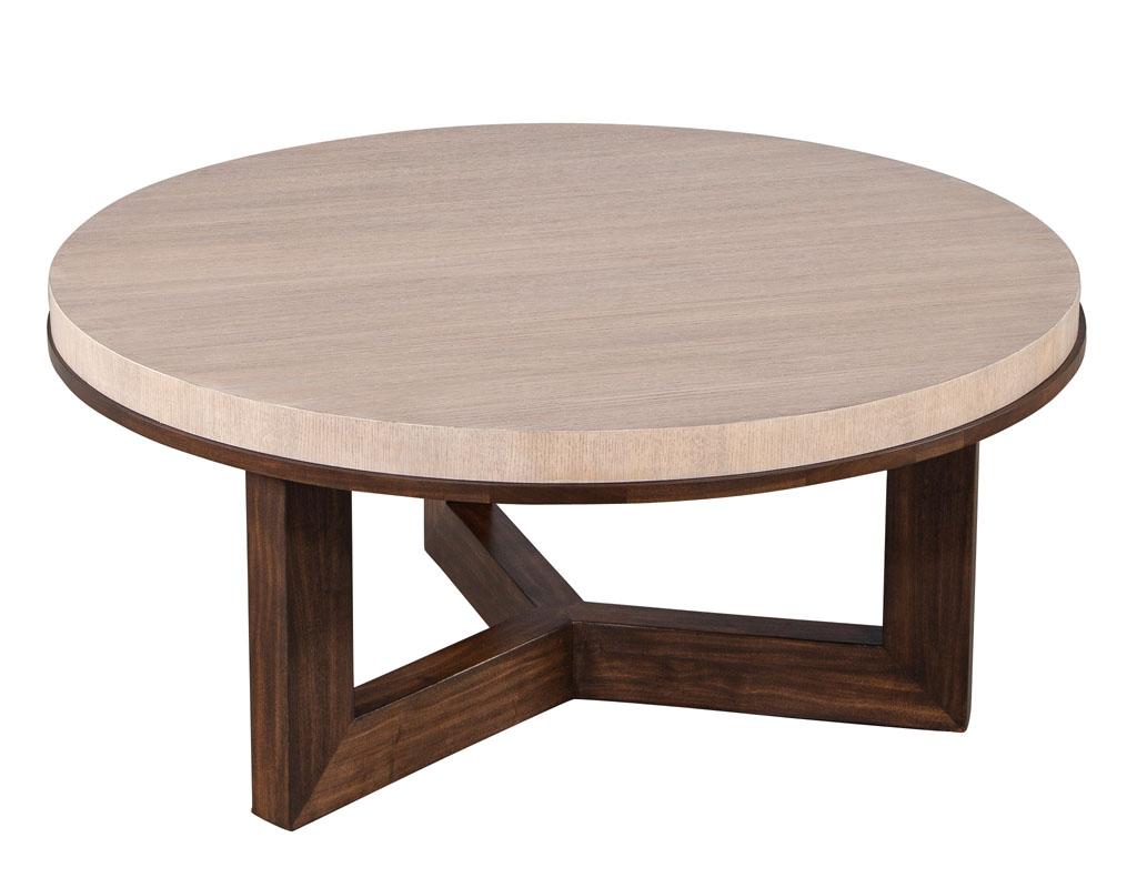 Modern Round Oak and Walnut coffee table. Mid-Century modern inspired clean design. Beautiful cerused oak top in a natural blush finish with brown walnut pedestal. Thick edge detail with walnut accent trim to match. Made in USA and custom finished
