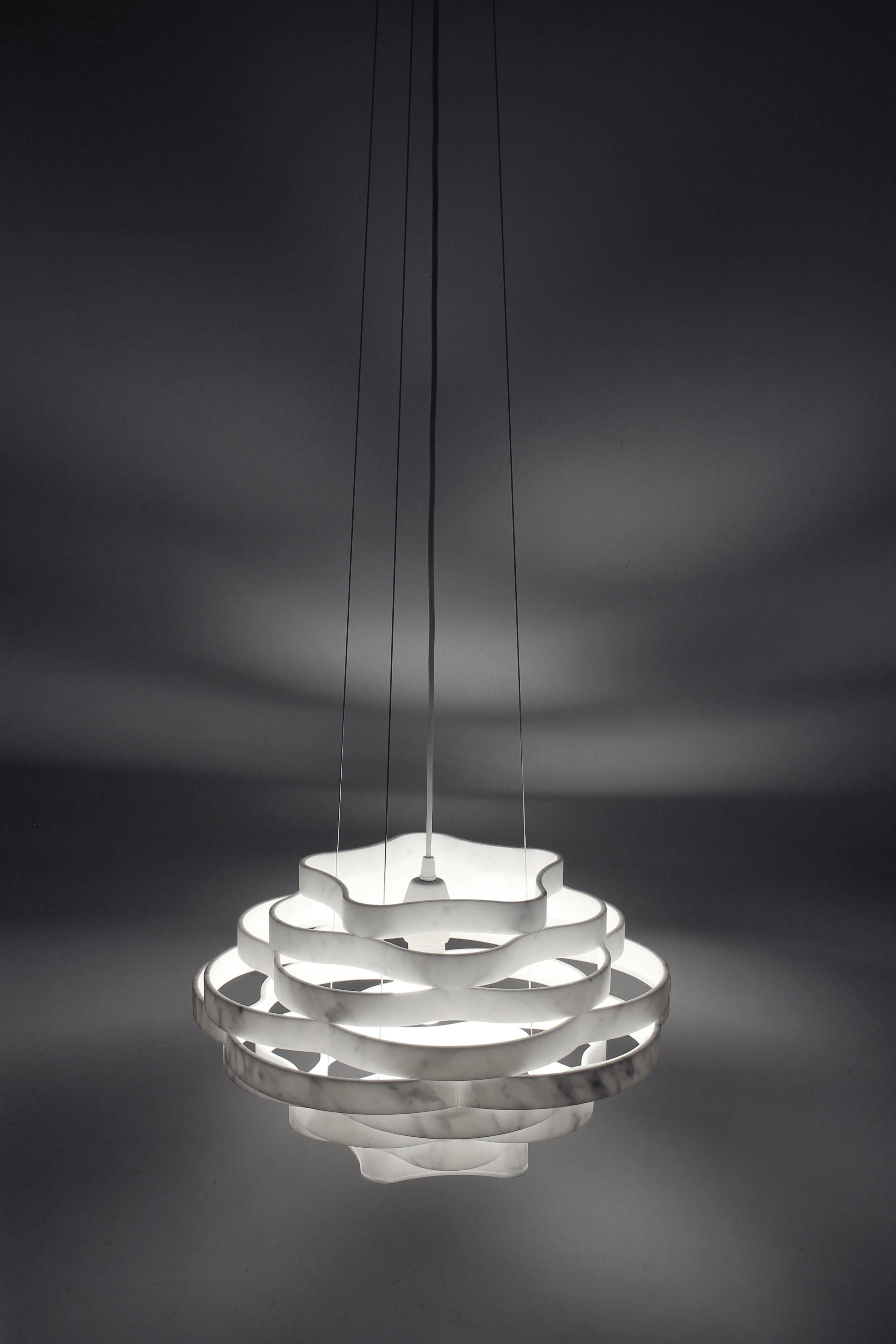 Suspension light made of White Carrara marble designed by Paolo Ulian in 2023. The light is called NEST, due to the shape of the lampshade.

The peculiarity of this lamp is that all the rings necessary for the construction are obtained from a single