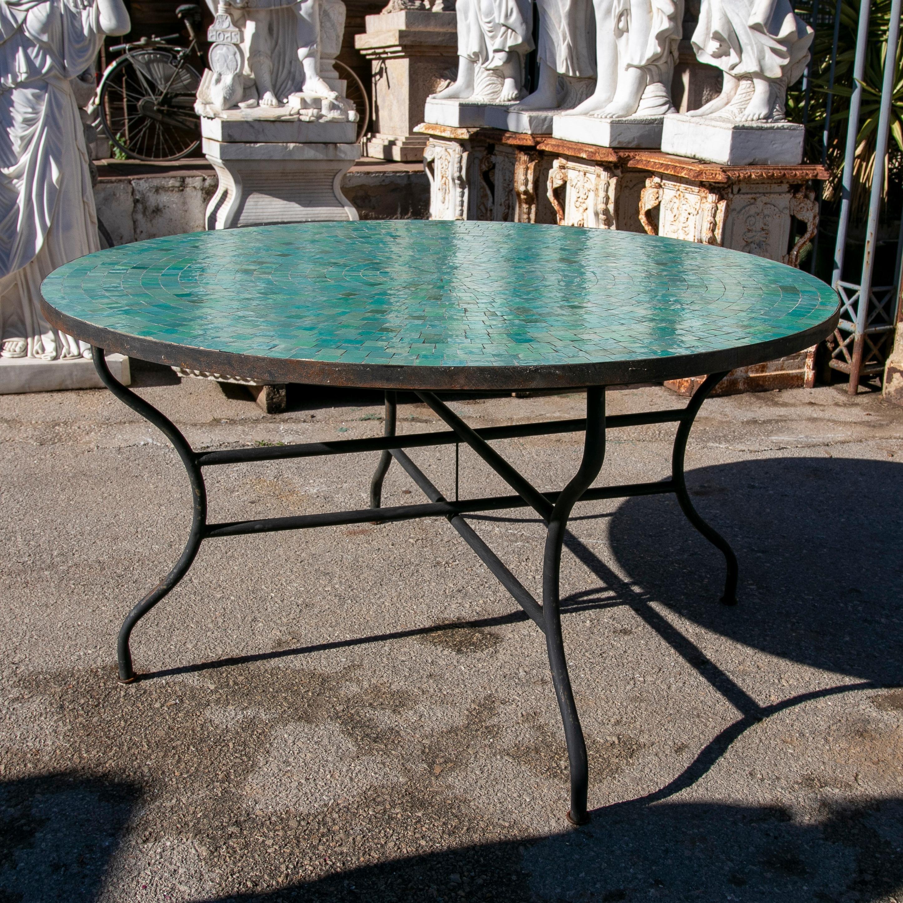 Modern round Spanish green glazed zellige tiles mosaic outdoor table with iron base.