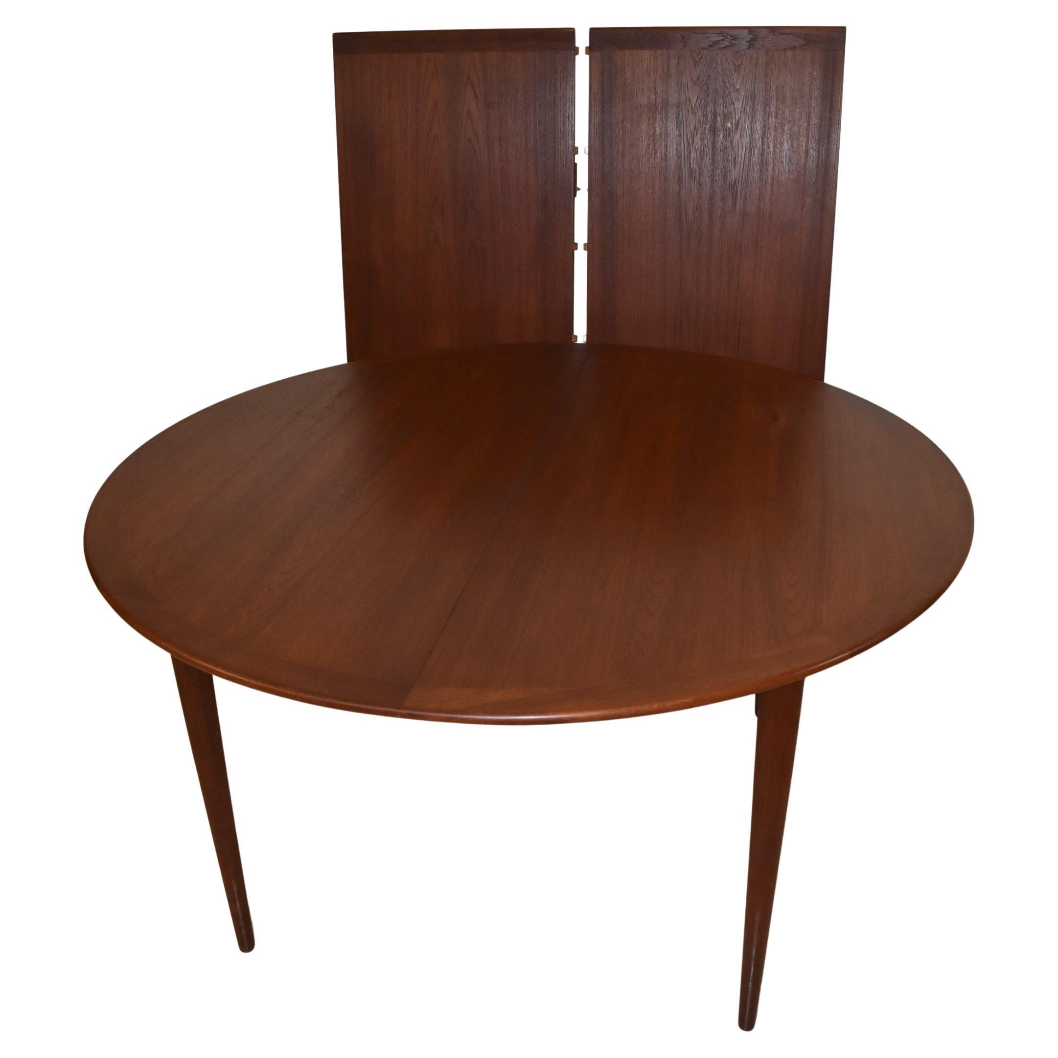 Mid-Century Modern round teak table by Grete Jalk for P. Jeppesens-Mobelfabrik. Tapered legs and two skirted 21