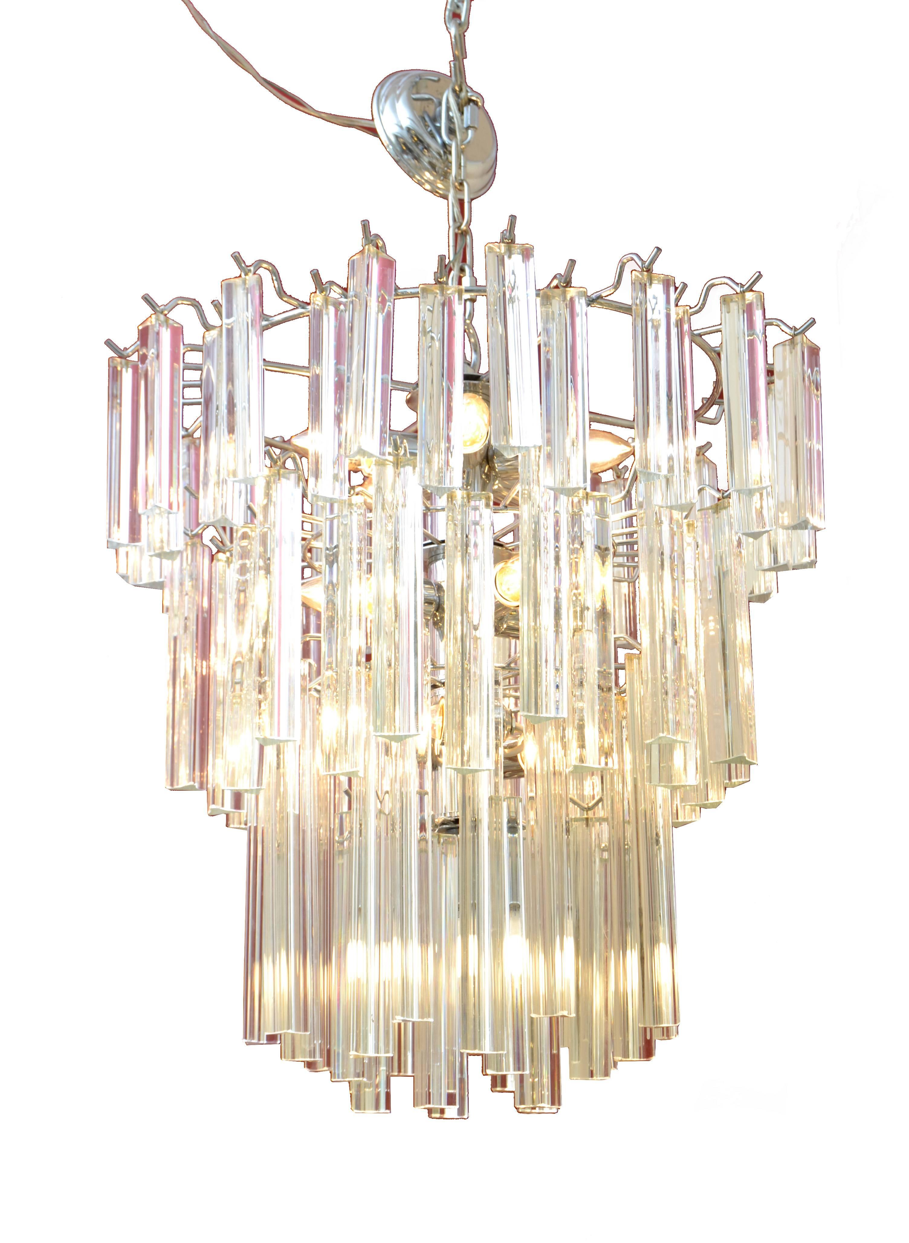 Modern round tiered crystal and chrome chandelier.
Consisting out of crystals in three different sizes.
In perfect working condition and uses 13 light bulbs with max 40 watts.
Comes with canopy and chain which is 8 inches long.
