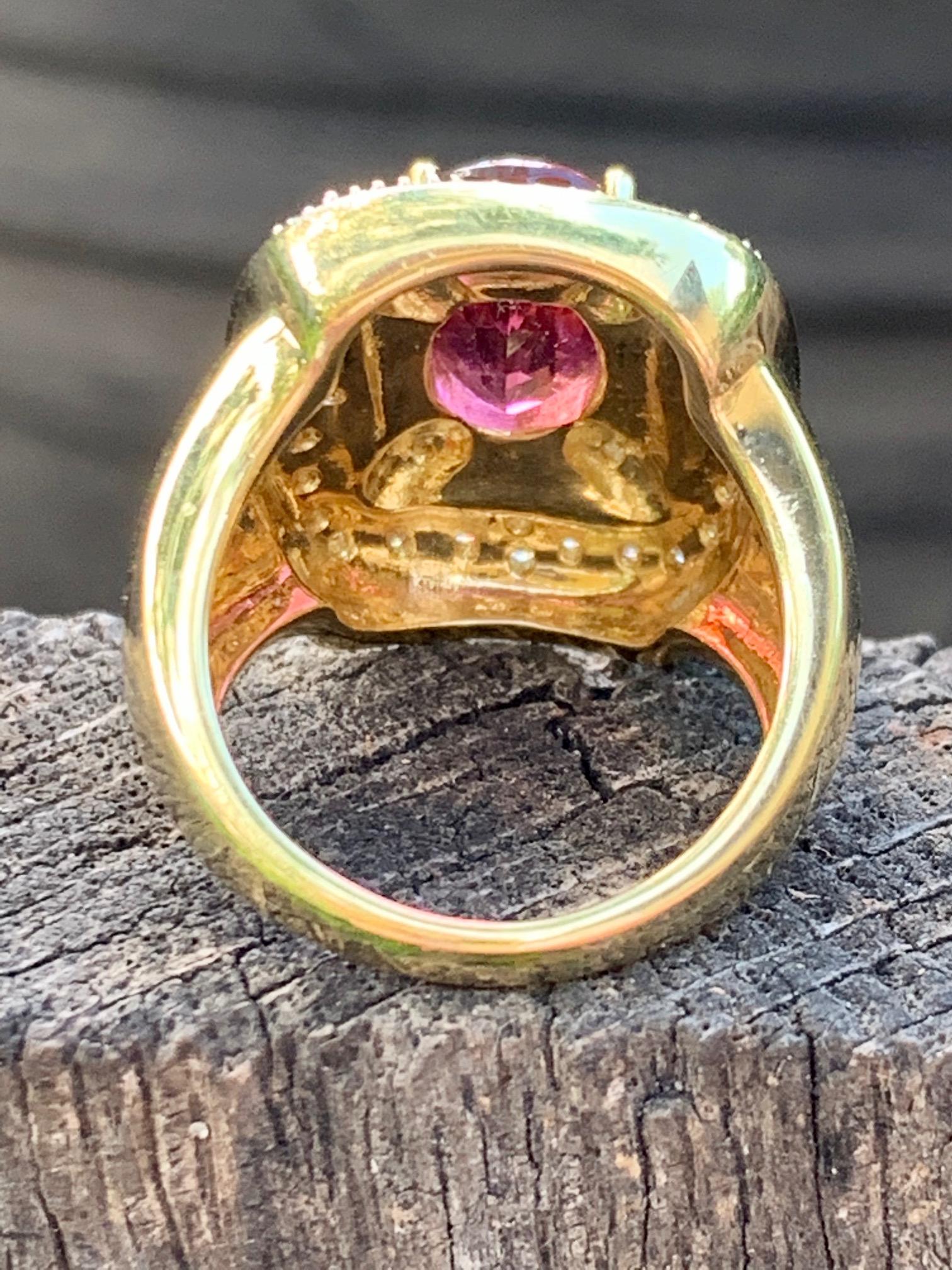 This modern 18K Rubellite Pink Tourmaline and Diamond fashion ring is stamped 18k and includes a designer's mark.

The Pink Tourmaline stone is approximately 3/8