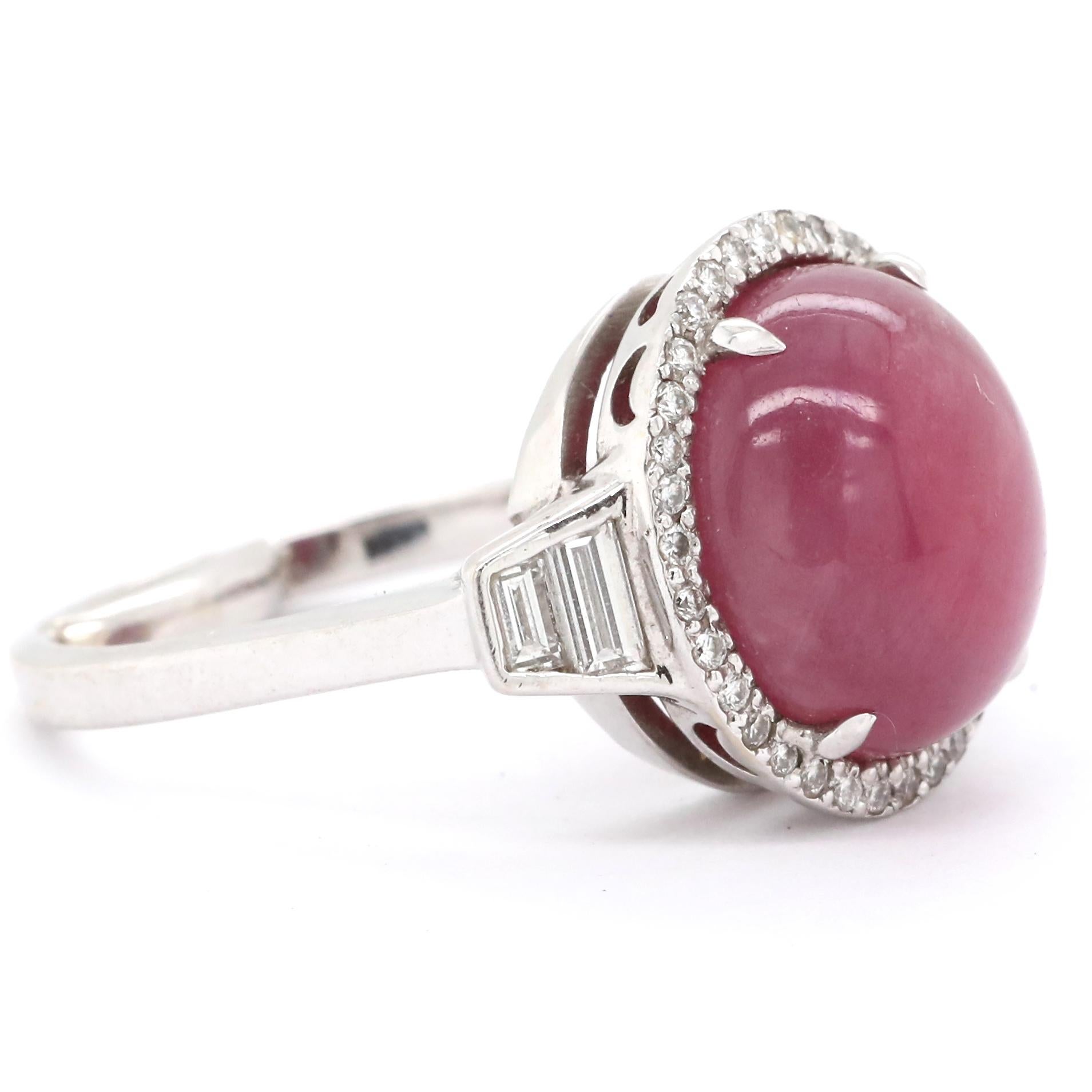 There is just something special about Cabochon cuts. They are unique, smooth and attractive. This is a Modern Ruby Diamond 18k Gold Ring. The Cabochon cut ruby is approximately 10.50 carat. Accompanied by 34 round brilliant cut diamonds and 4