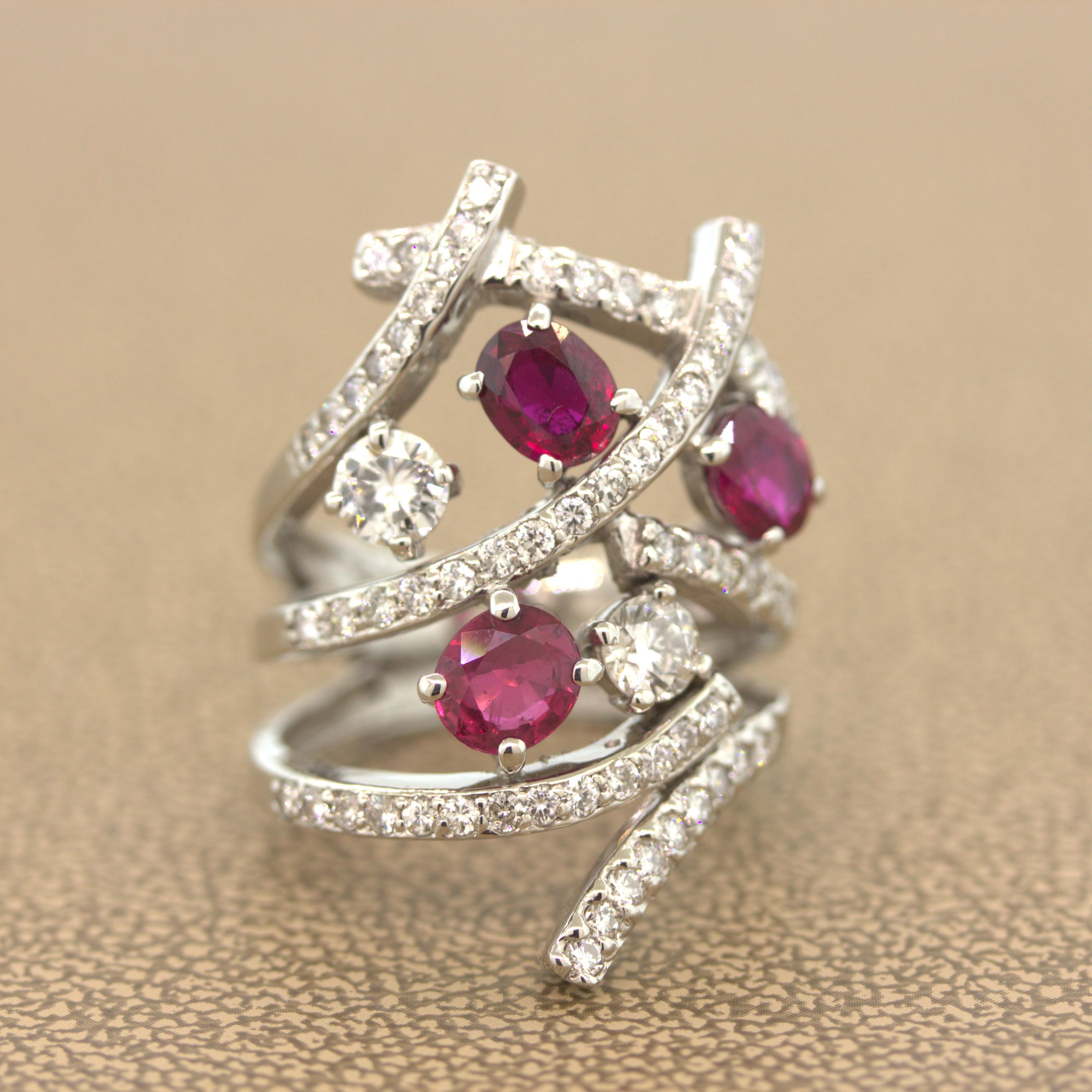 A modern take on the classic bypass ring, this lovely piece features 3 vivid red oval shape rubies weighing a total of 2.21 carats. They are excellent color and clarity and are accented by cascade of diamonds, which include two larger round diamonds