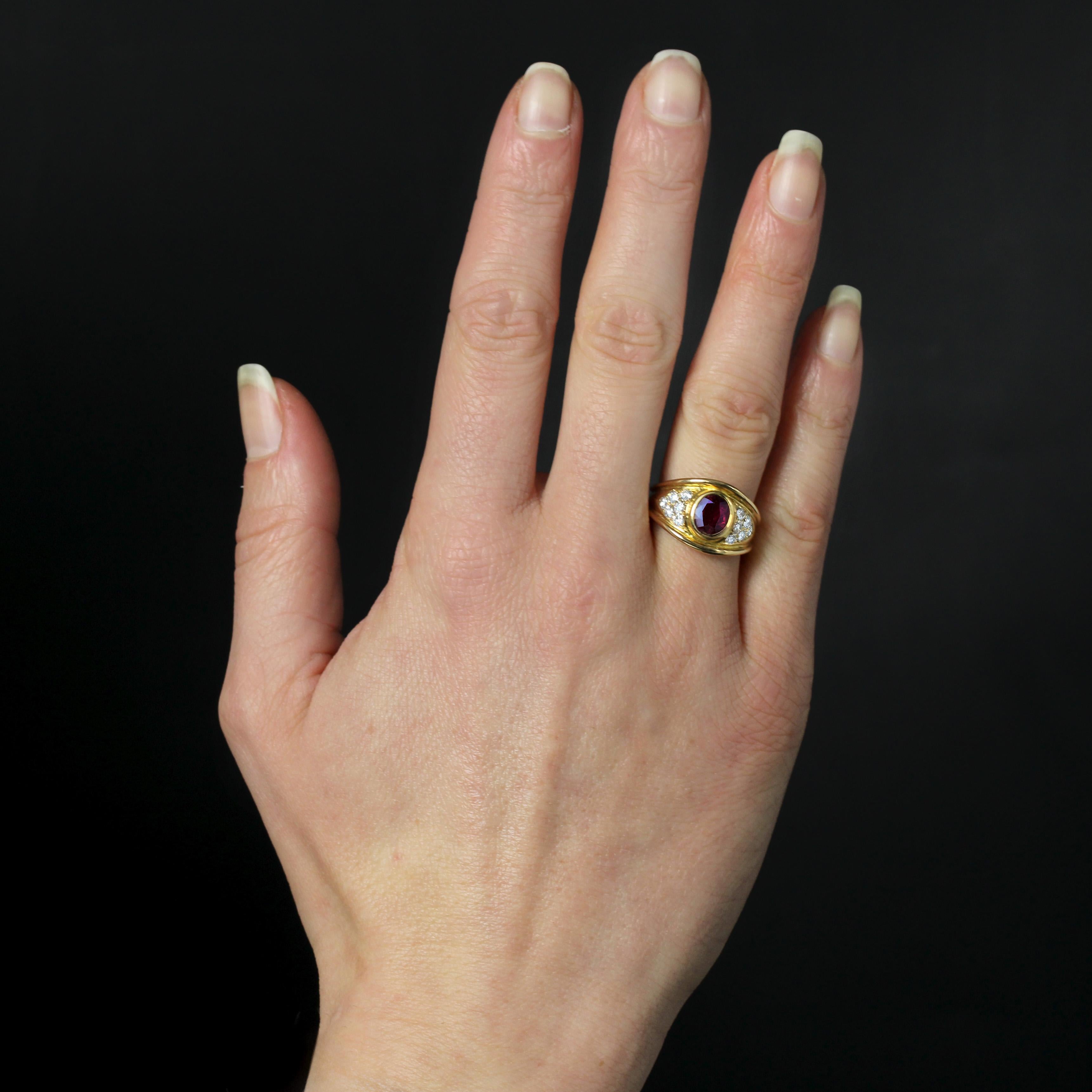Ring in 18 karat yellow gold, eagle head hallmark.
This second-hand ring features a wide top band, closed-set in the center with an oval faceted ruby, shouldered on either side by 6 modern brilliant-cut diamonds on an arrowhead setting.
Weight of