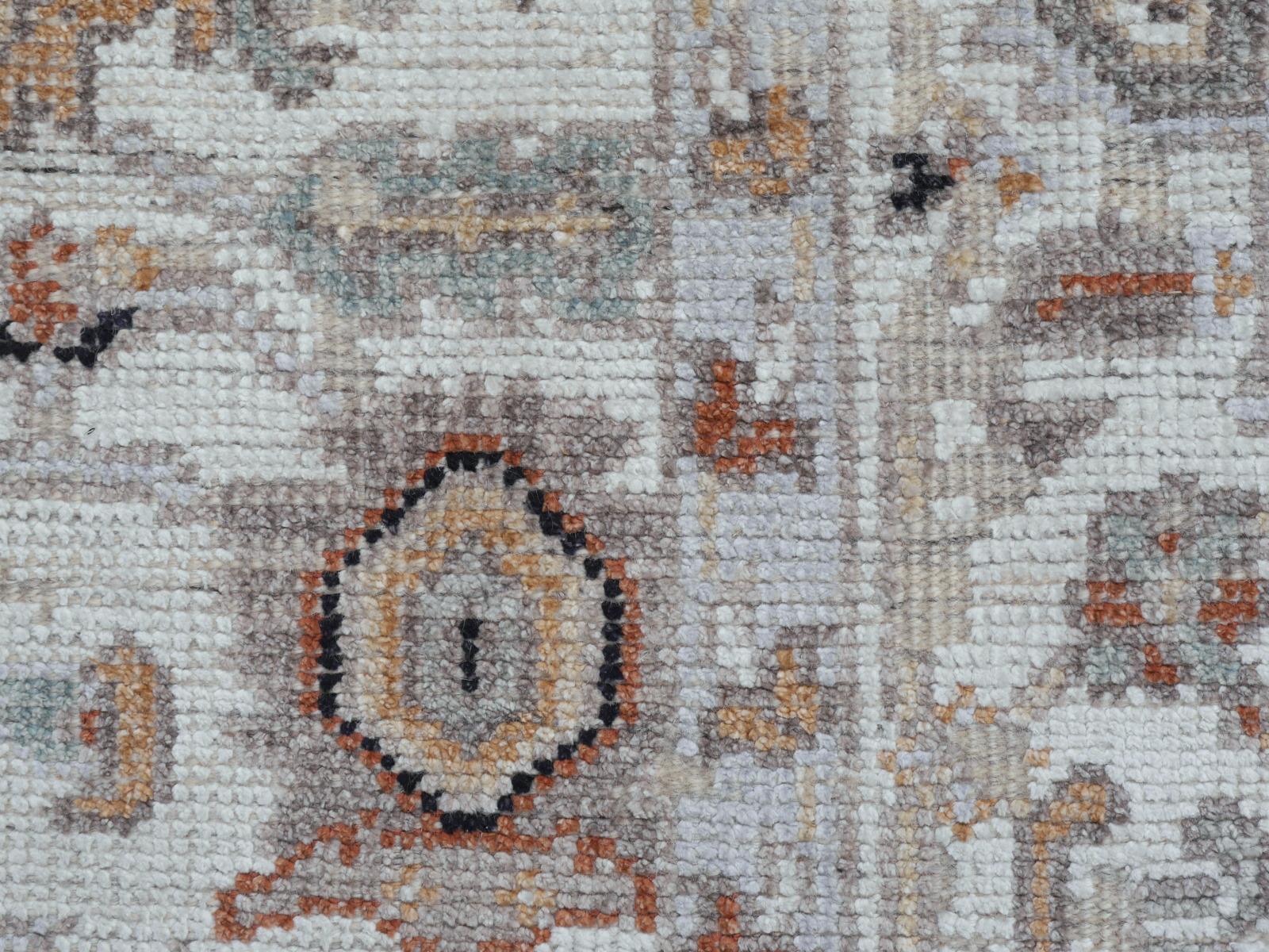 A beautiful 8 x 10 ft. modern contemporary transitional rug hand knotted wool pile and bamboo silk. On a light beige field, the design of traditional Oushak and Heriz elements standing next to each other executed in beiges, blues and copper